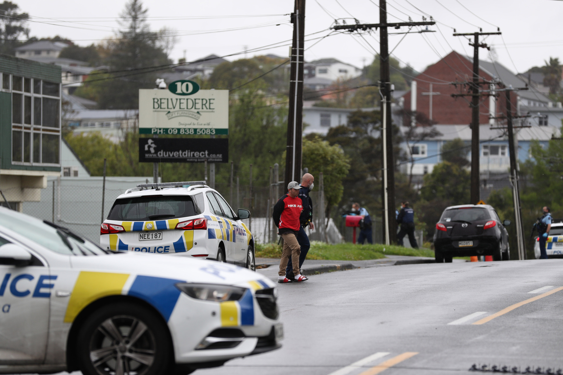 Armed police on View Rd, Henderson as they make an arrest at a Head Hunters gang house. Photo / Hayden Woodward