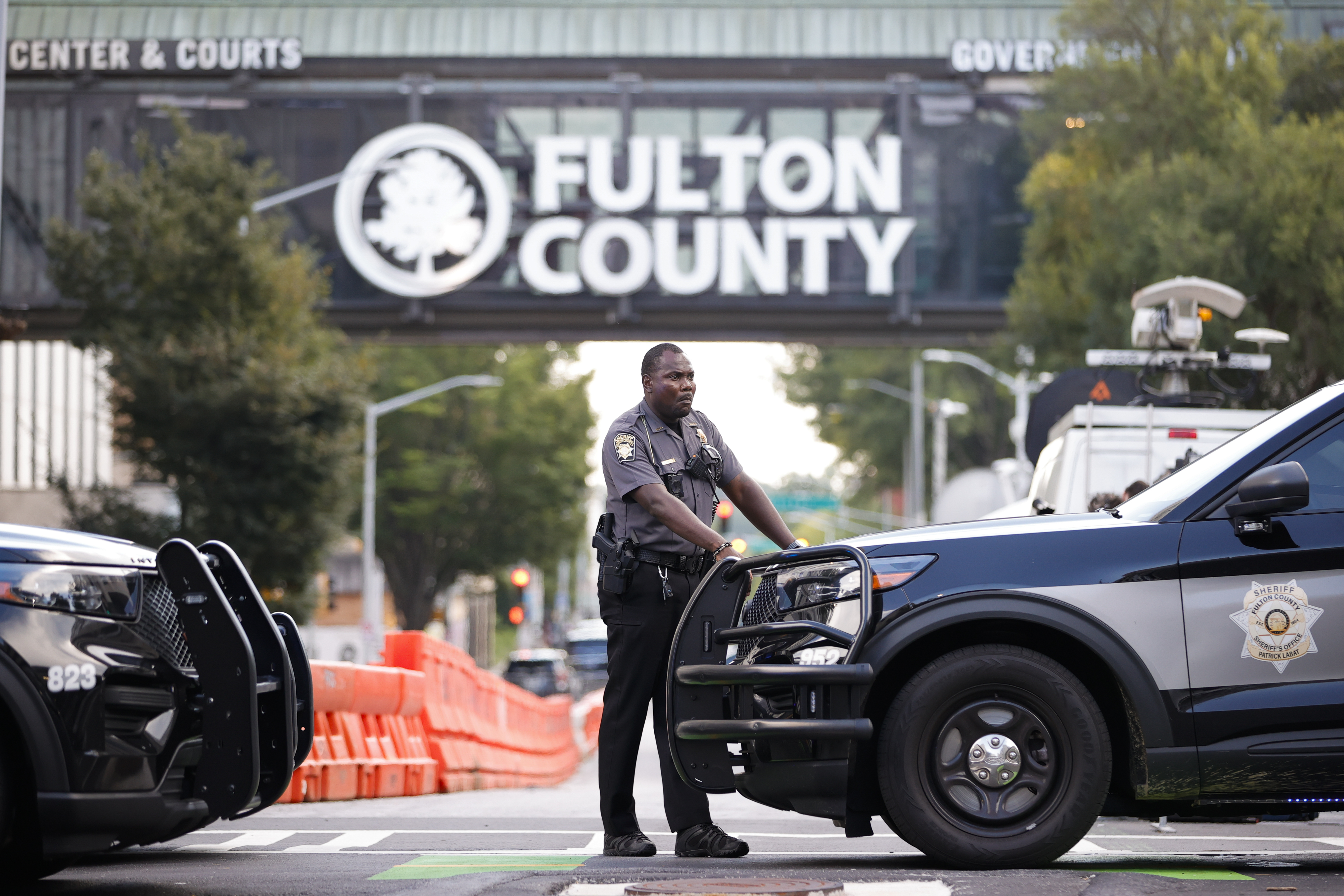 A sheriff's deputy looks on near the Fulton County Courthous. Photo / AP / Alex Slitz