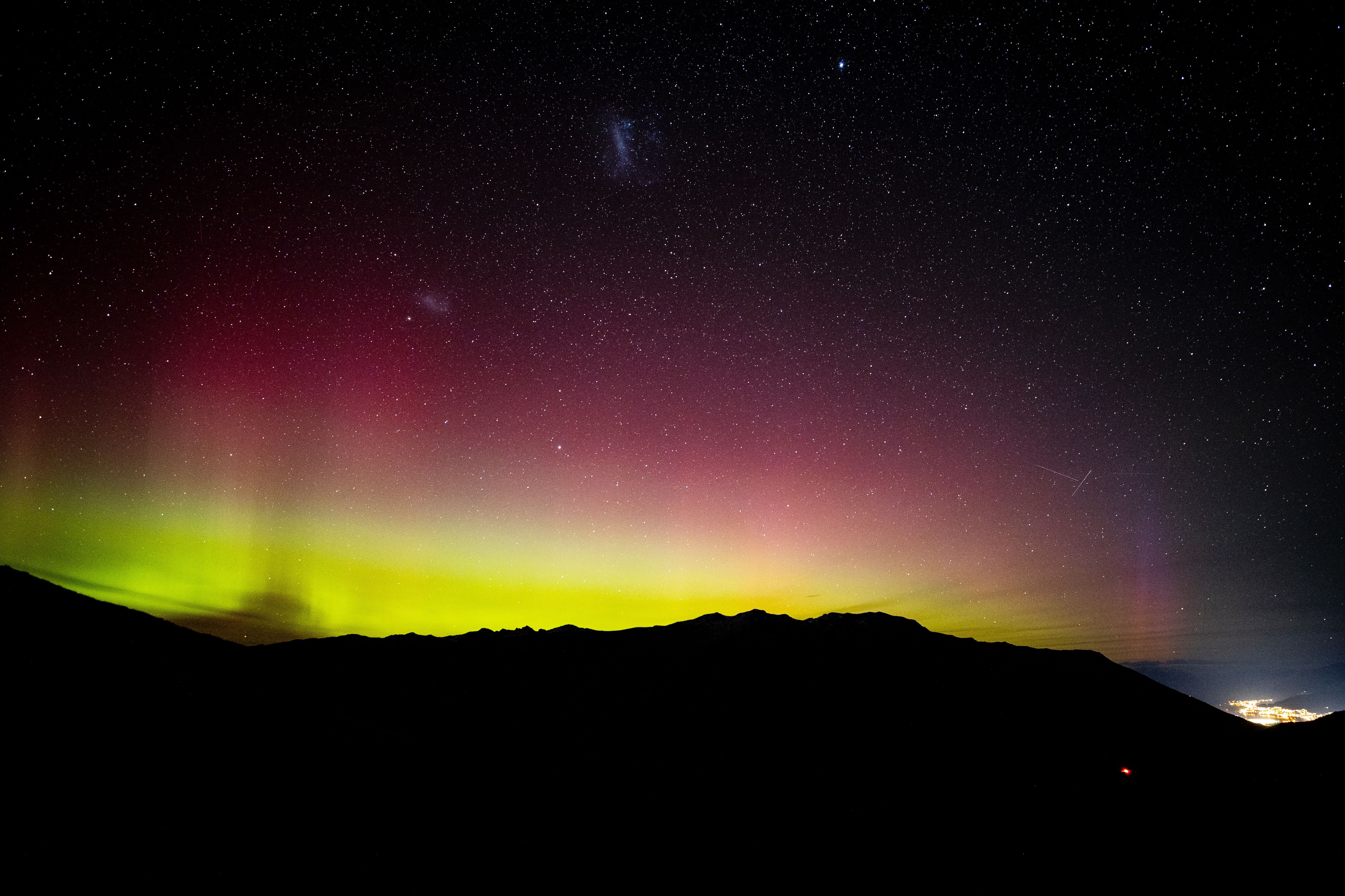 The Southern Lights from the top of the Crown Range looking over Queenstown. Photo / George Heard