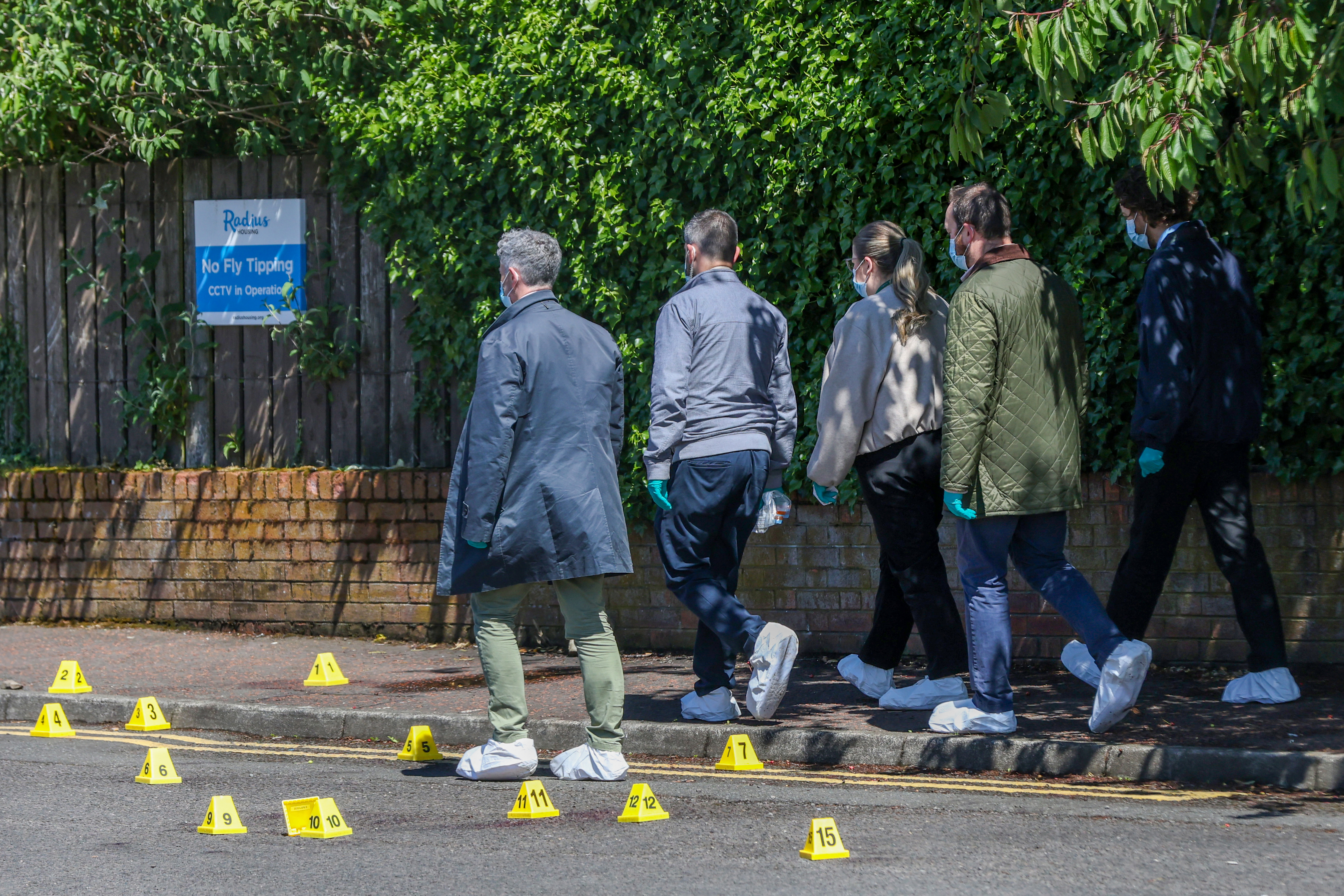 Police officers search the scene of the stabbing in north Belfast, Northern Ireland. Photo / Paul Faith, AFP