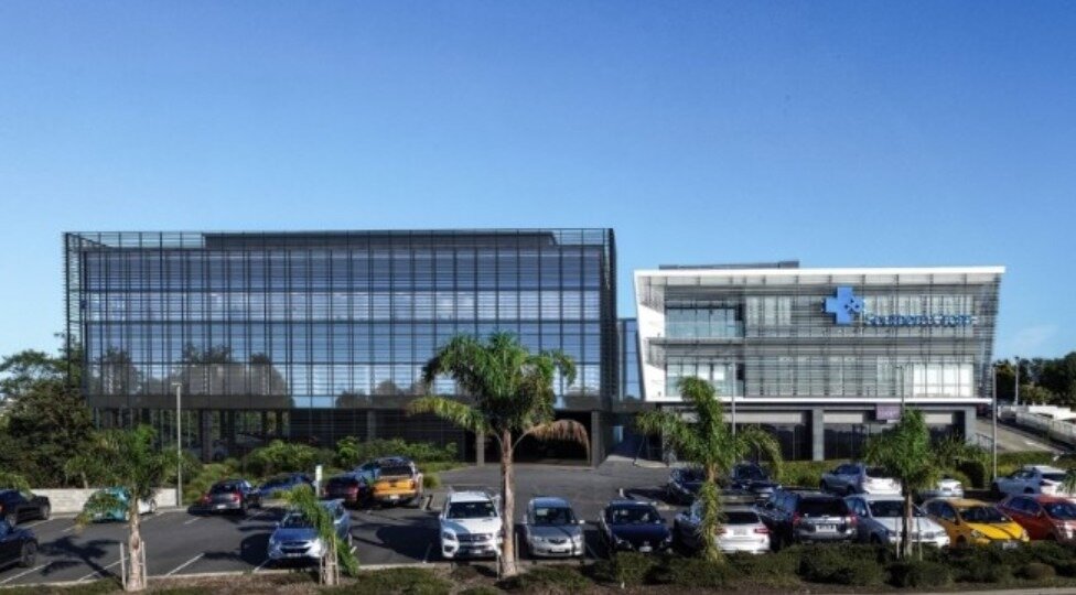 The Southern Cross plans for its Wairau Rd property on the North Shore. The planned new building is on the left. The white building is existing. Image / Southern Cross Health Trust