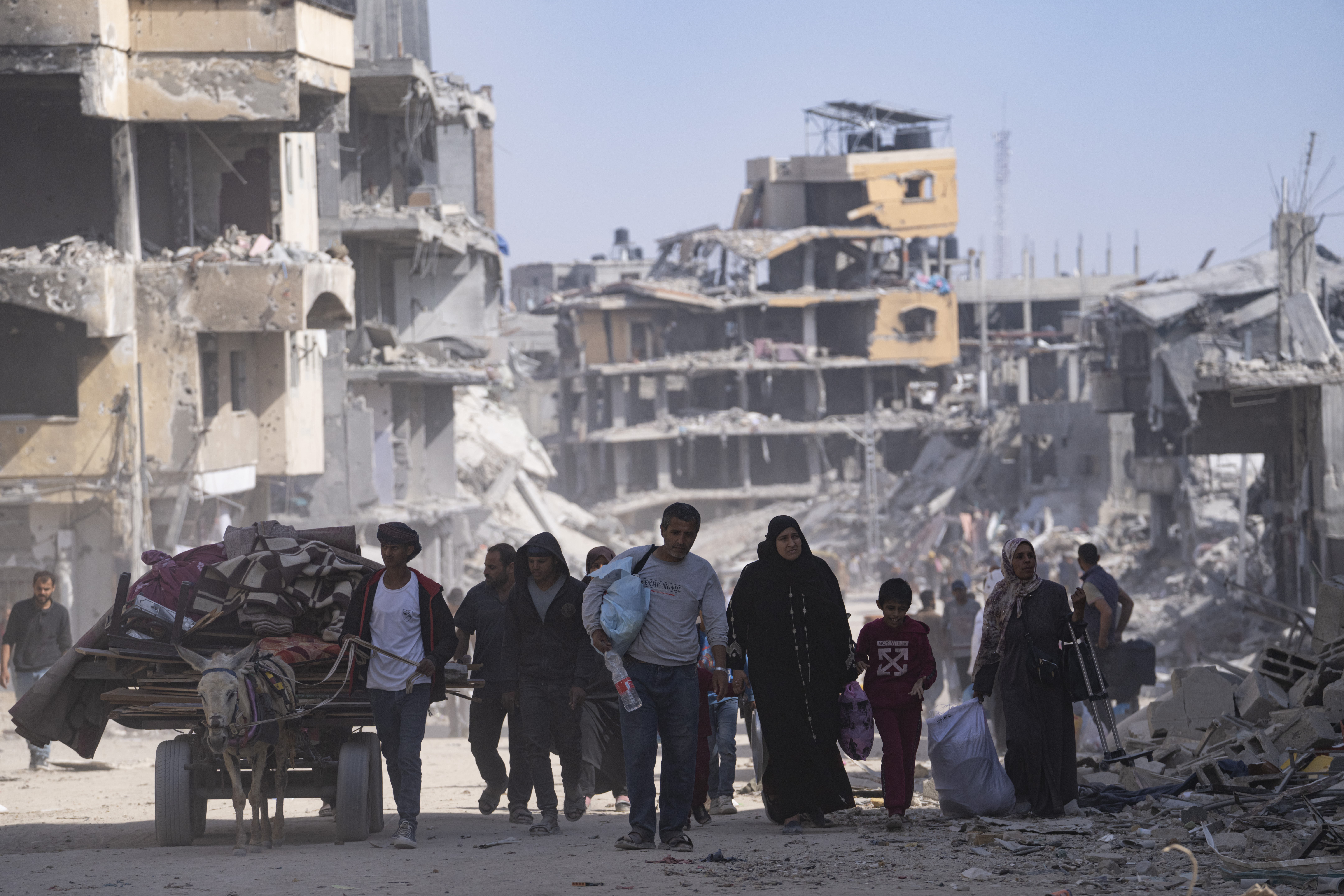 Palestinians walk through the destruction in the wake of an Israeli air and ground offensive in Khan Younis, southern Gaza Strip. Photo / AP
