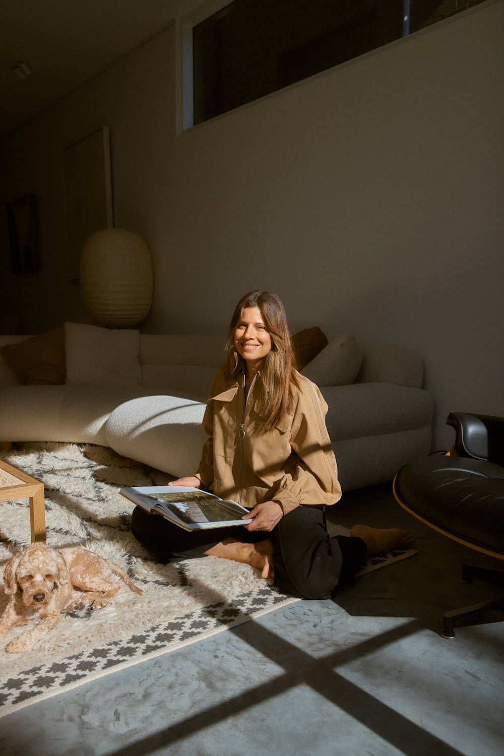 Carla Oates relaxes at home in Bondi Beach with her dog, Wolfie.