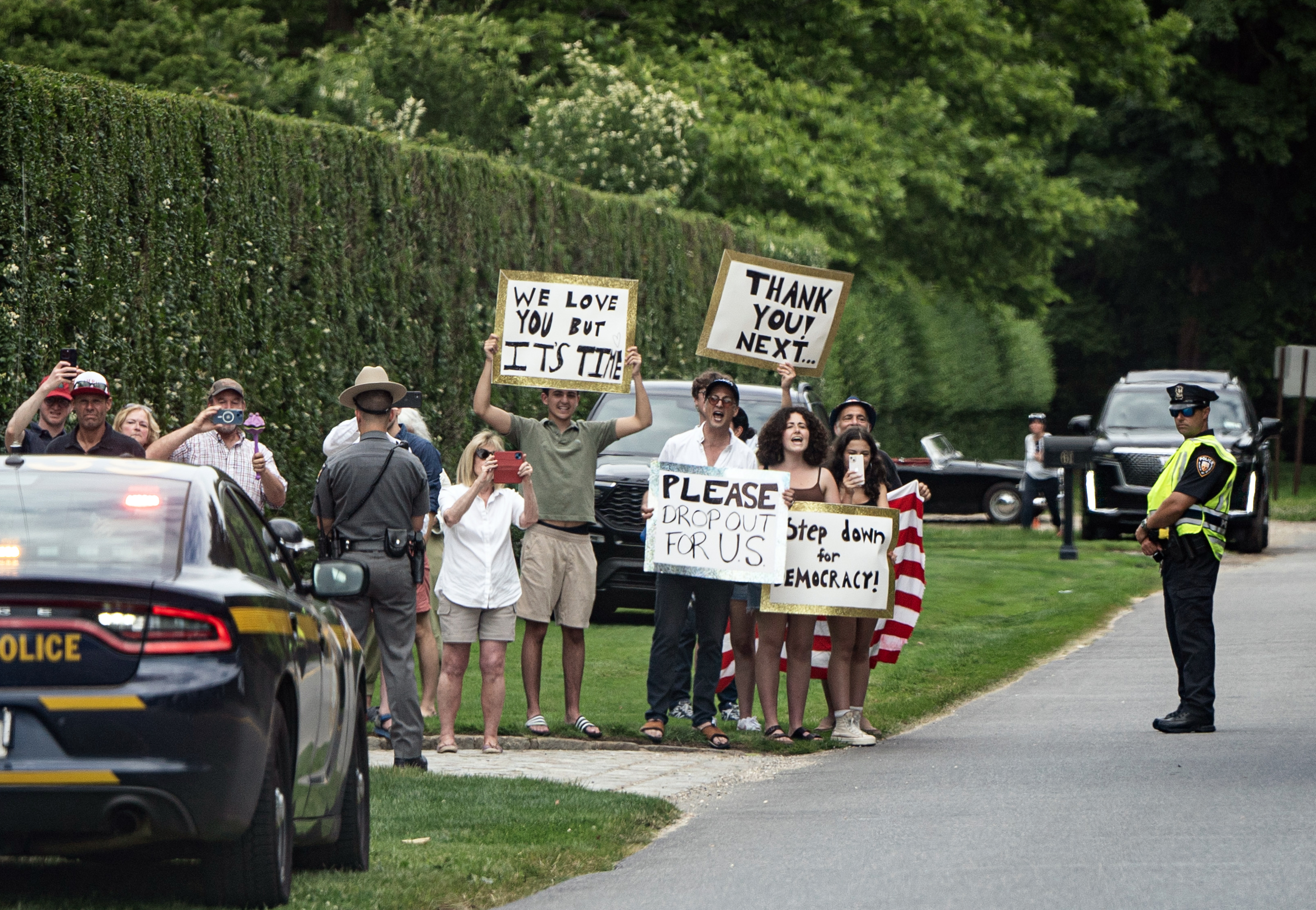 People hold signs calling for Biden to step aside in East Hampton, New York, on June 29. Photo / Haiyun Jiang, The New York Times
