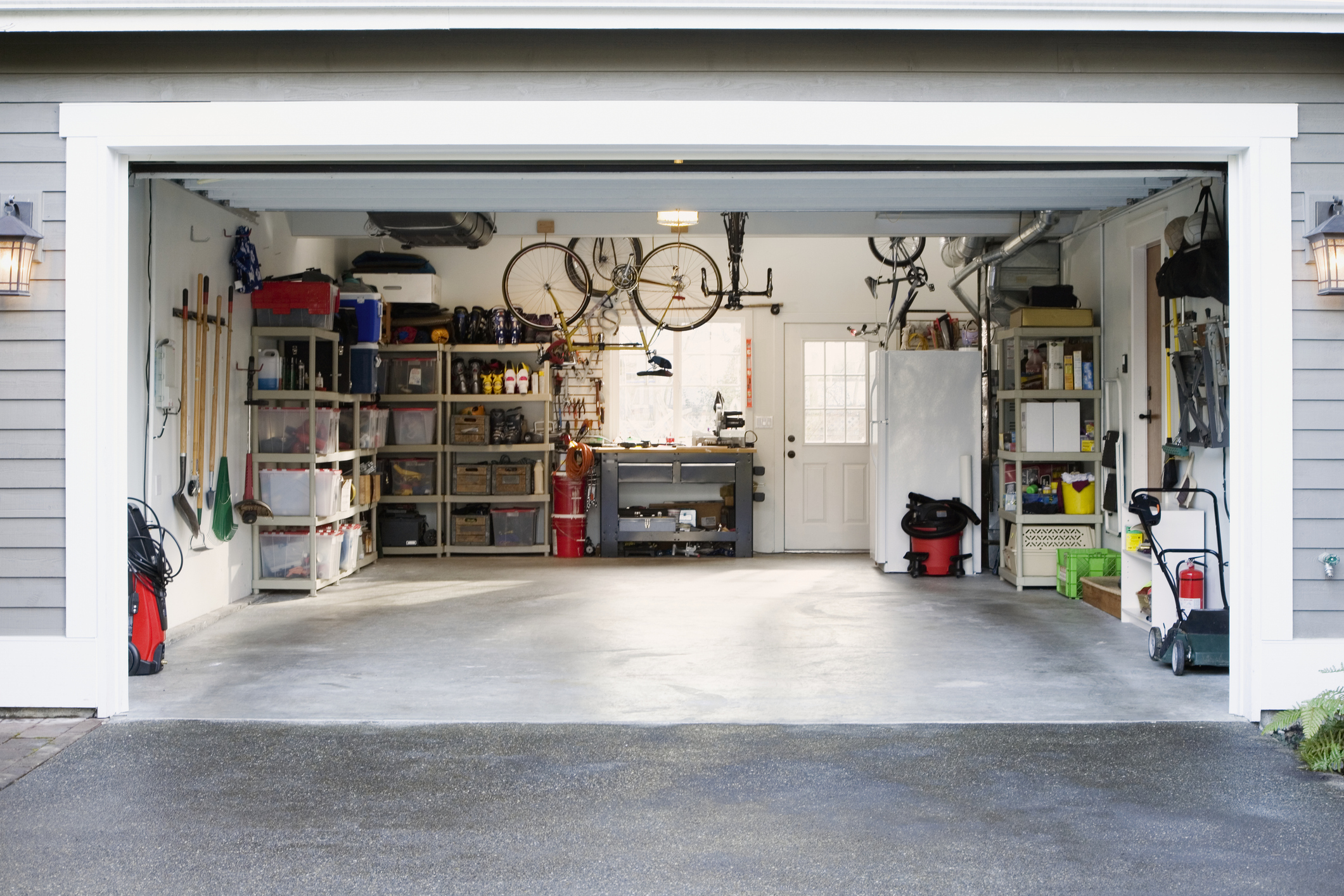 A garage with bikes, fridge and other household items. Photo / Getty Images