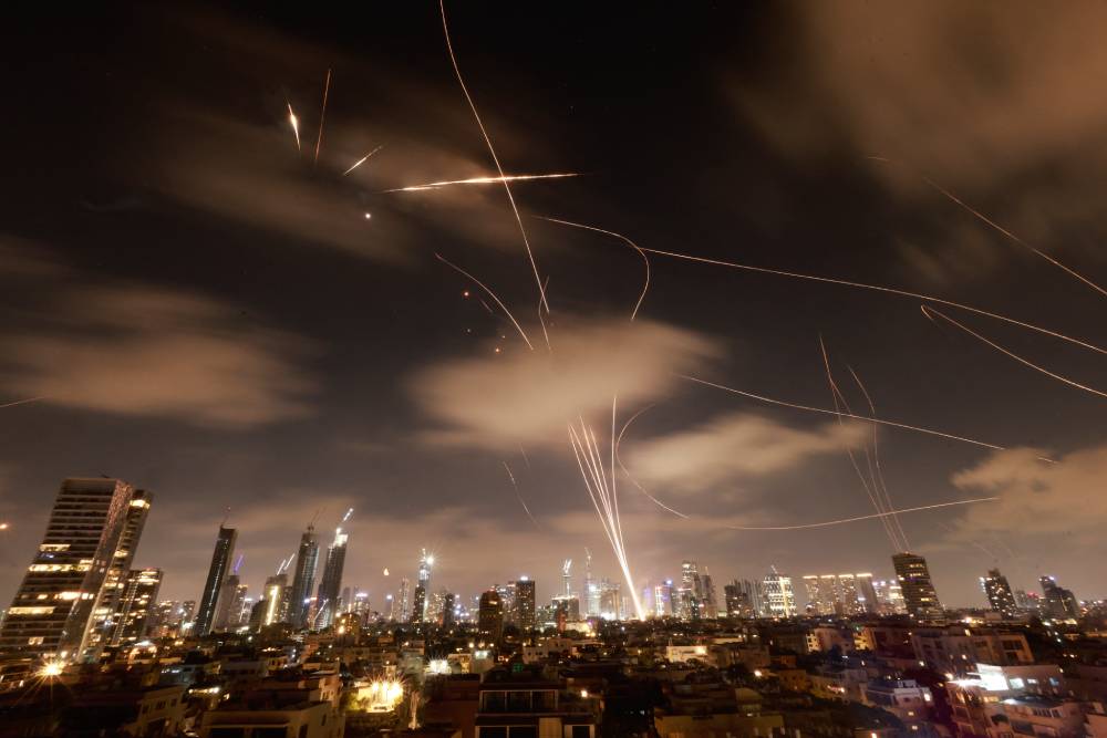 Israeli air defence systems are activated to intercept Iranian missiles over Tel Aviv. Photo / Menahem Kahana, AFP