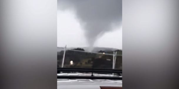 This is the frightening moment a tornado ripped through Mangawhai Heads, taking rooves off buildings. Photo / Sam Garratt