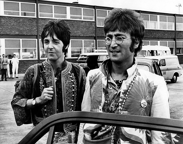 Paul McCartney and John Lennon returning to Heathrow Airport from holiday in Greece. Photo / Getty Images
