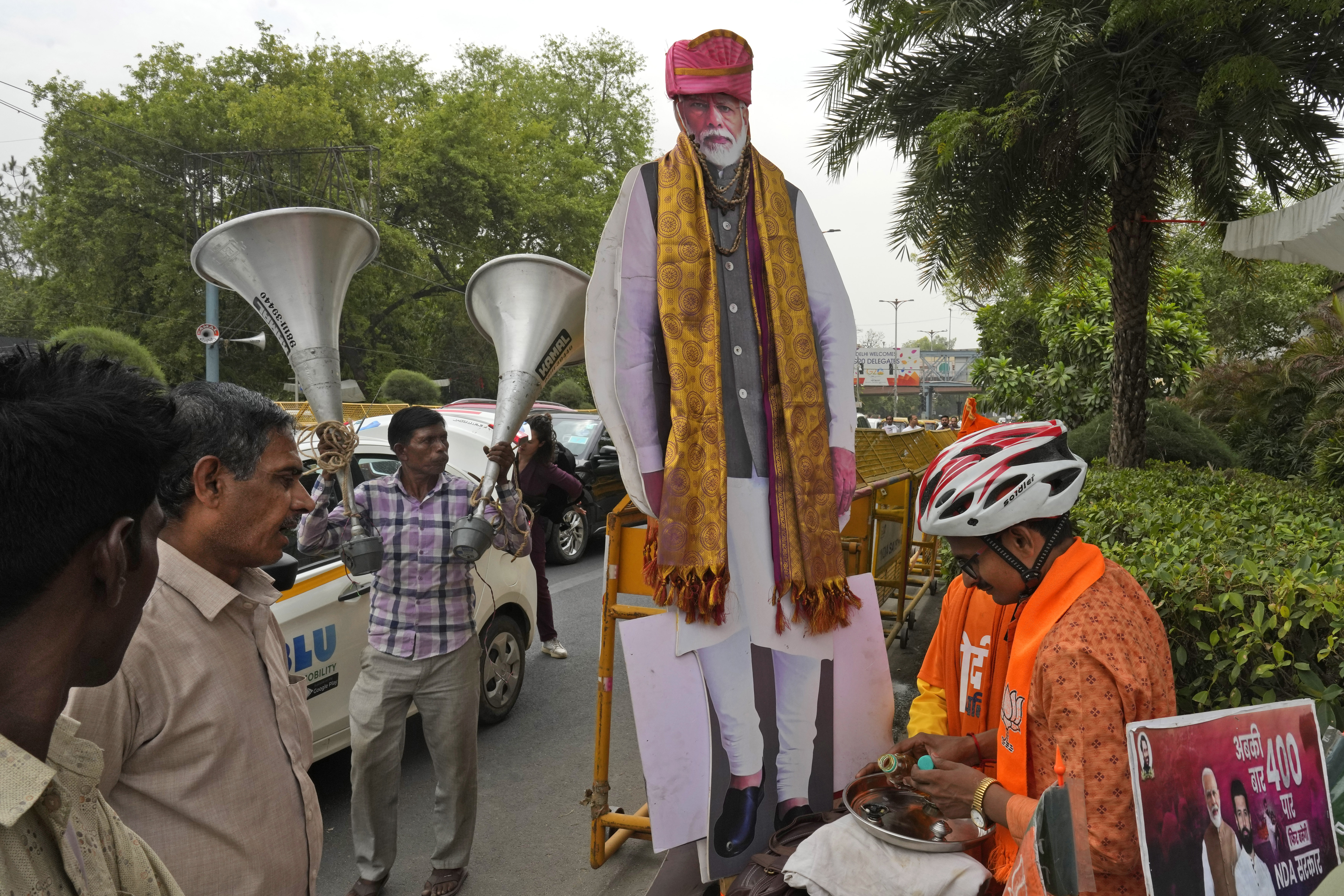A Bharatiya Janata Party supporter prepares to offer prayers to a cut-out of Indian Prime Minister Narendra Modi. Photo / AP