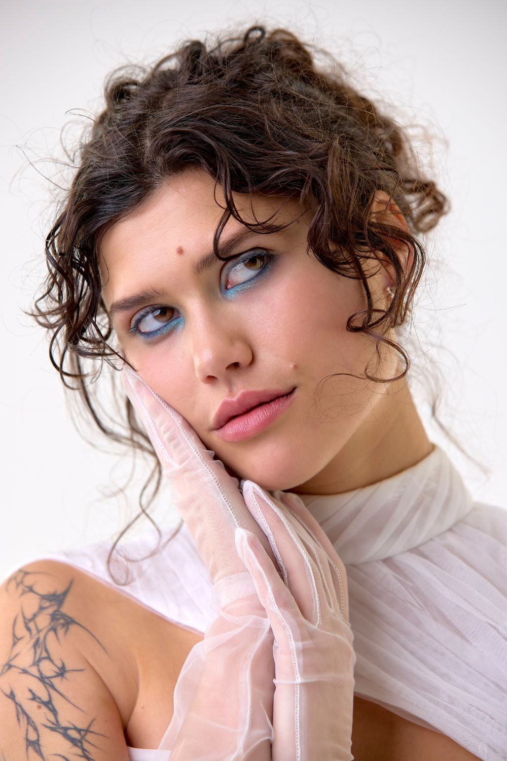Hera Couture dress POA and shrug POA. Meadowlark earrings $349. Gloves stylist’s own. Photo / Babiche Martens
