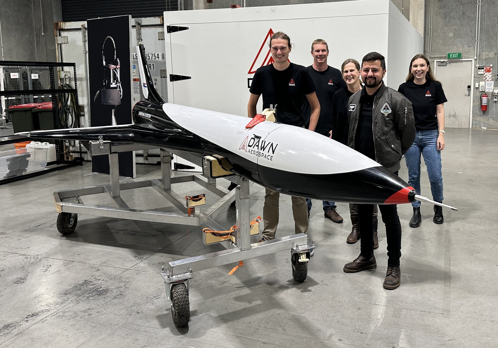 Dawn Aerospace staff including CEO Stefan Powell (front left) and remote test pilot Iagho Amaral (front right) at the firm's Christchurch R&D and testing plant with the Mk-II Aurora spaceplane demonstrator. Photo / Chris Keall
