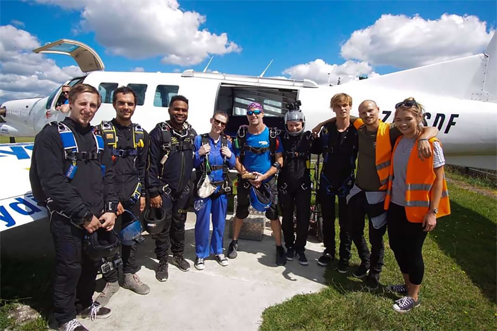 Abby Creane (in blue) with friends of her dead brother, Jack, ahead of a tribute skydive jump over Parakai to release his ashes. Photo / Supplied