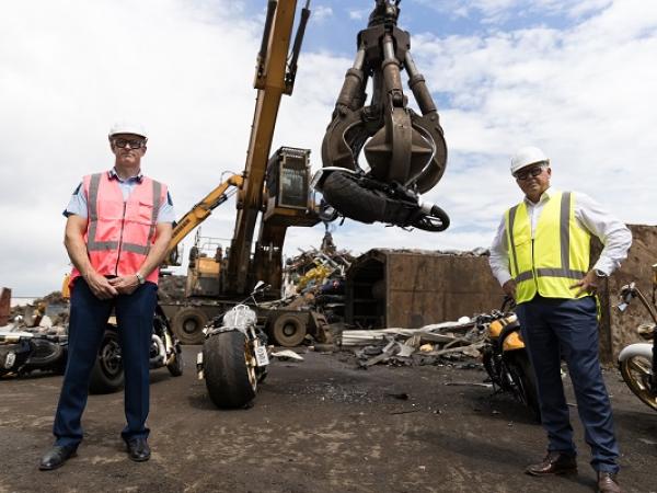 Police Commissioner Andrew Coster and Police Minister Mark Mitchell watch as the Comanchero bikes are scrapped. The pair have had an awkward working relationship.