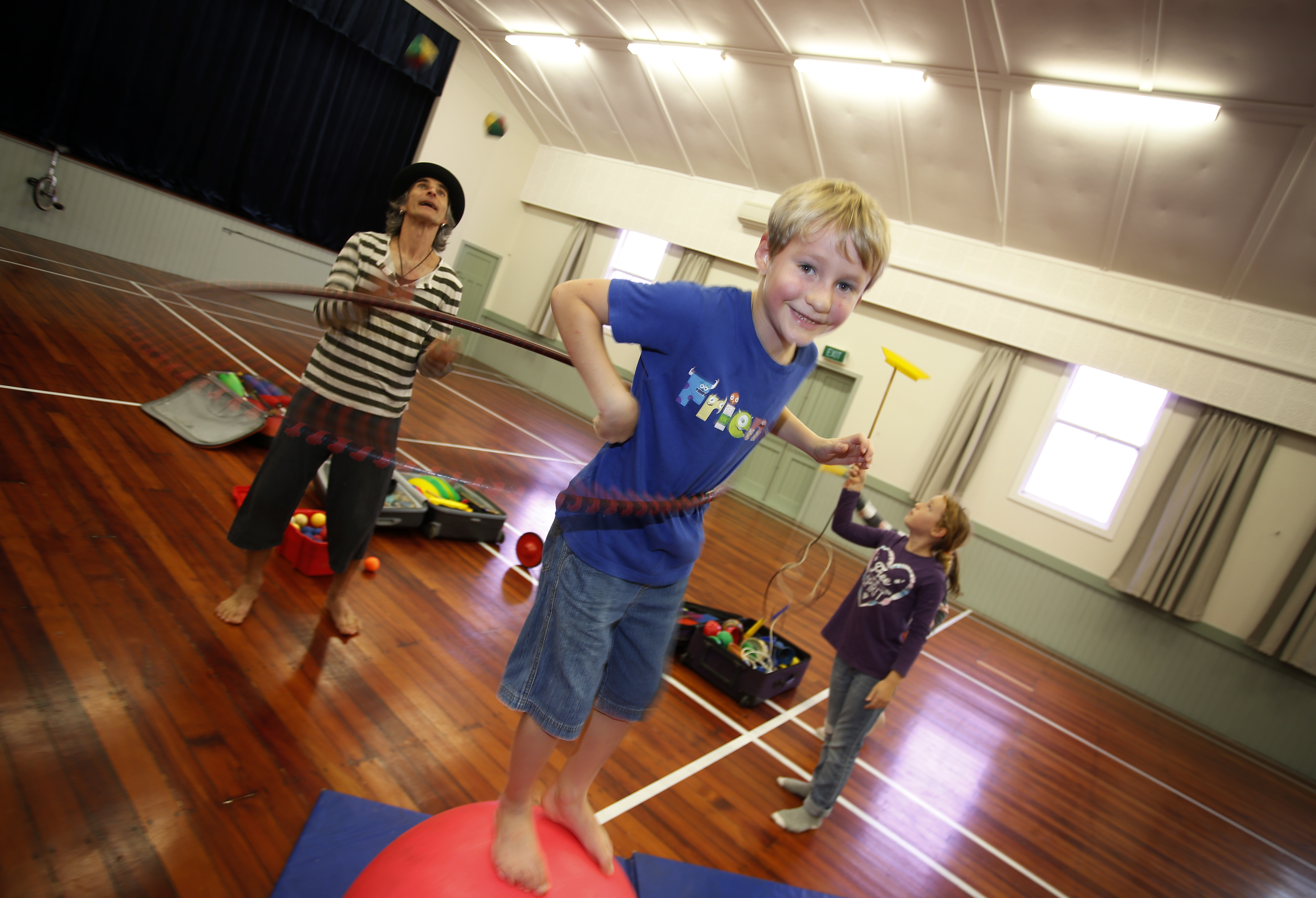 Circool Circus teacher Achmed Abman with students Hamish Bartlett, 8, and Ara Bartlett, 11. Photo/Michael Cunningham