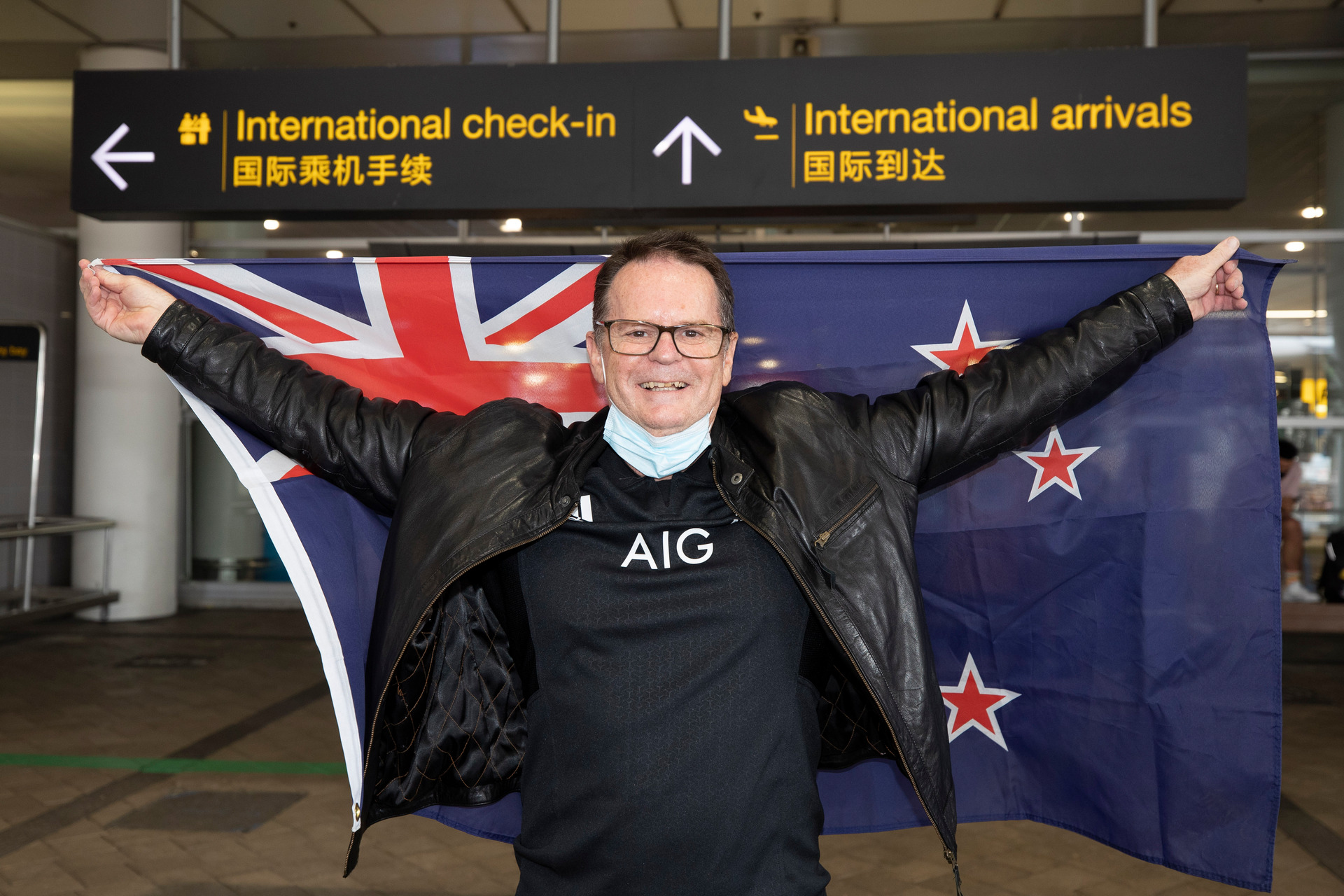 John Davis, who hasn't been back since 2019, arrives on the Qantas flight from Australia and welcomed by his daughter Amber Davis and grand-daughter Maddison. Photo / Brett Phibbs