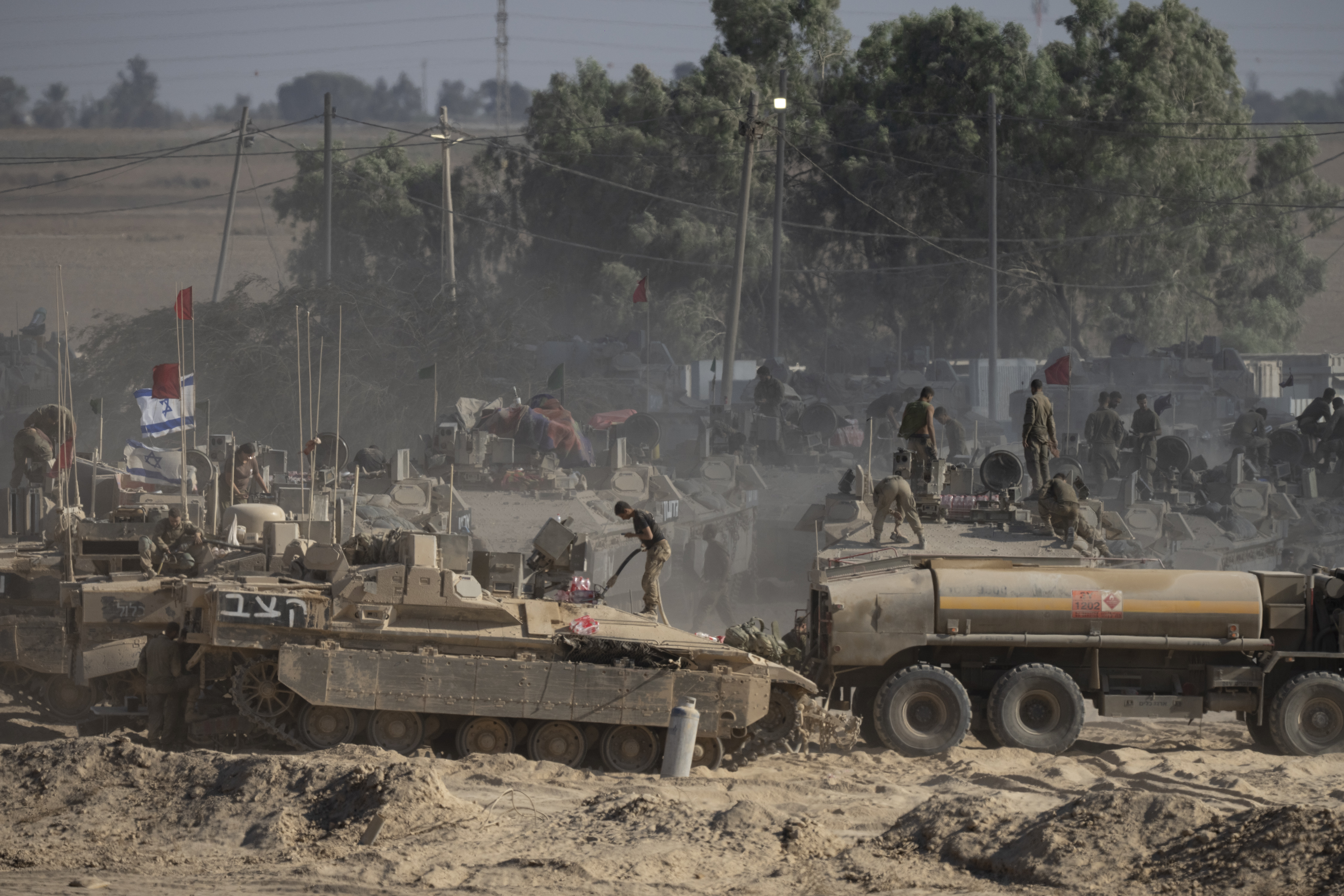 Israeli soldiers organise military equipment while standing on armoured personnel carriers near the border with the Gaza Strip on August 6, 2025. Photo / Getty Images