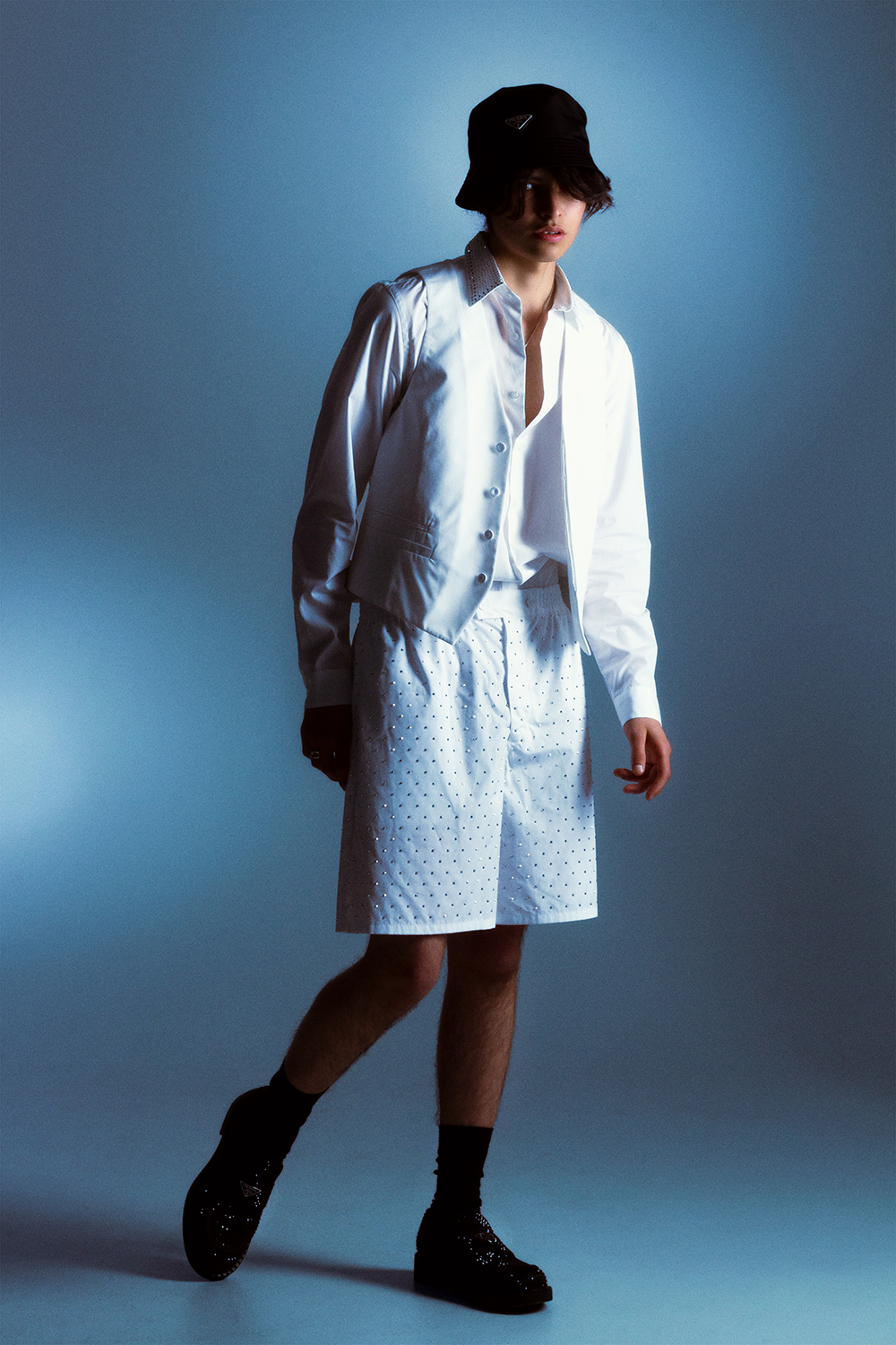 Amadeo wears a waistcoat, shirt, shorts, bucket hat and crystal-studded loafers, from Prada’s pre-fall 2021 collection. Model’s own necklace and socks. Photo / Mia Vinaccia