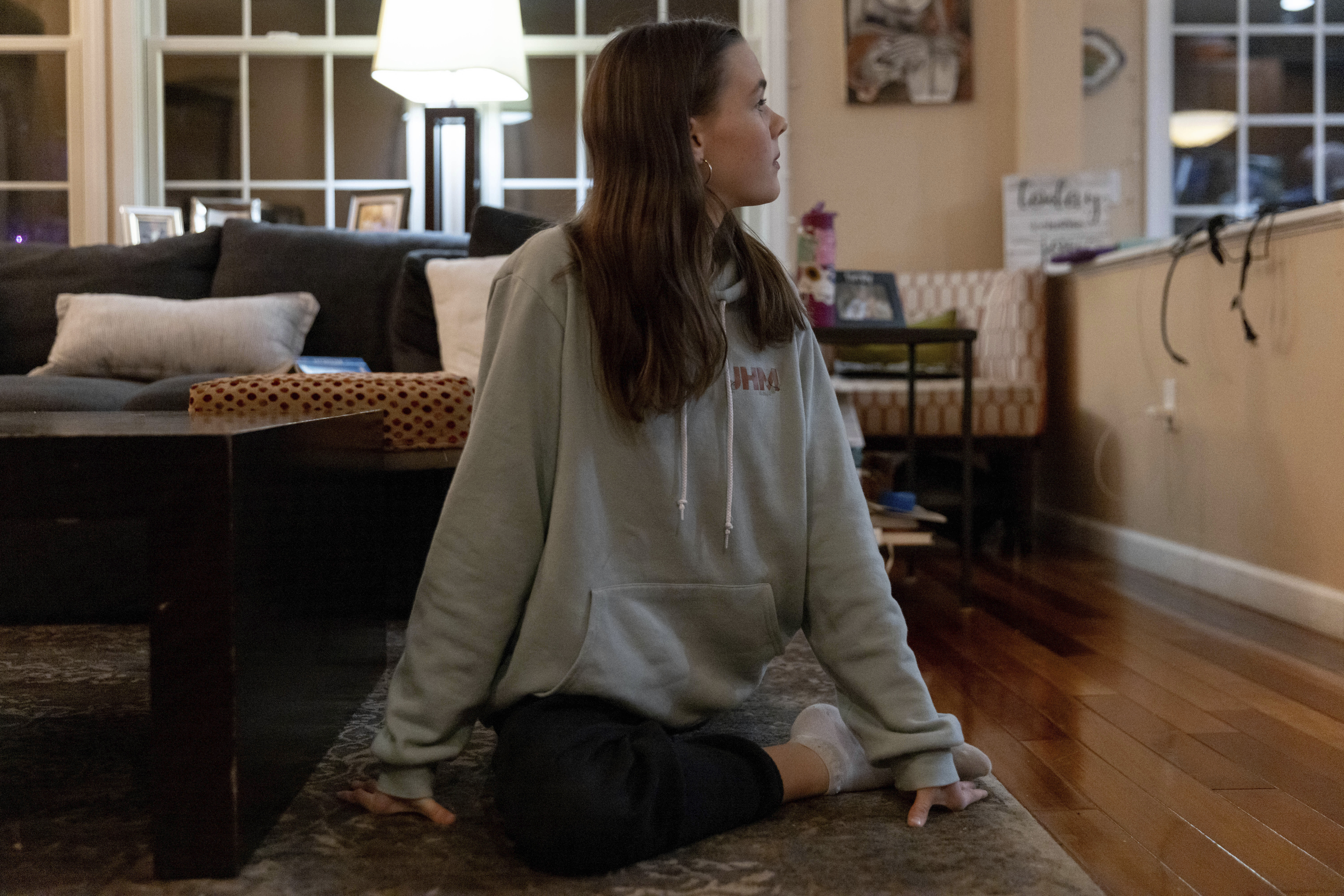 Sutton Bulkeley, 13, practices stretching in her living room. Photo / AP