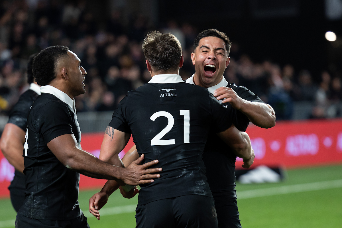 All Blacks Sevu Reece, Cortez Ratima and Anton Lienert-Brown hug after their win over England. Photo / Photosport