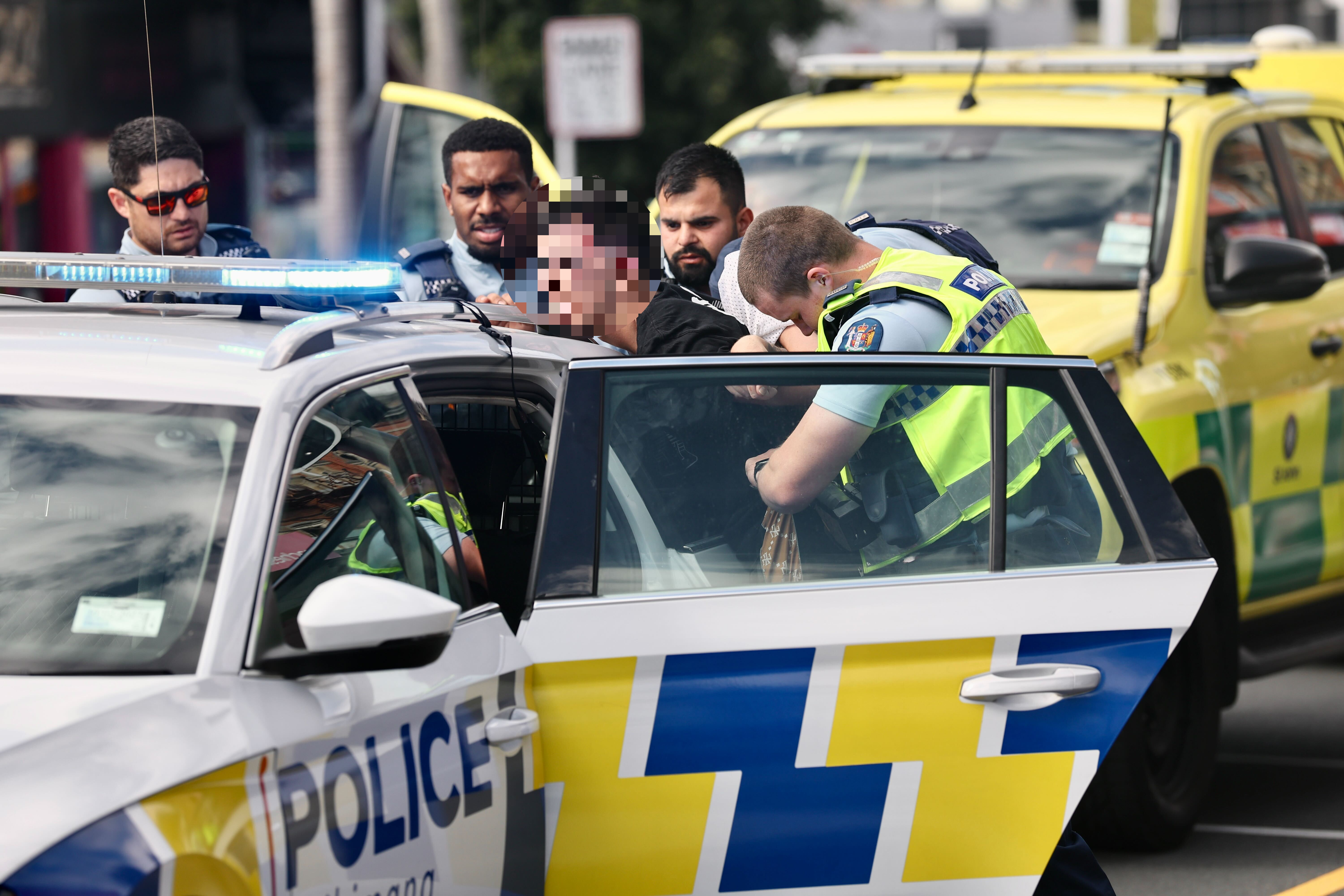 A man is handcuffed in the city. Photo / Dean Purcell