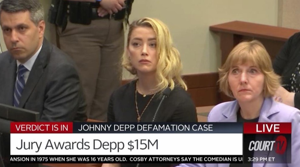 Amber Heard, and her lawyers Elaine Bredehoft, and Ben Rottenborn, react as the verdict is read in the courtroom. Photo / Court TV, via AP