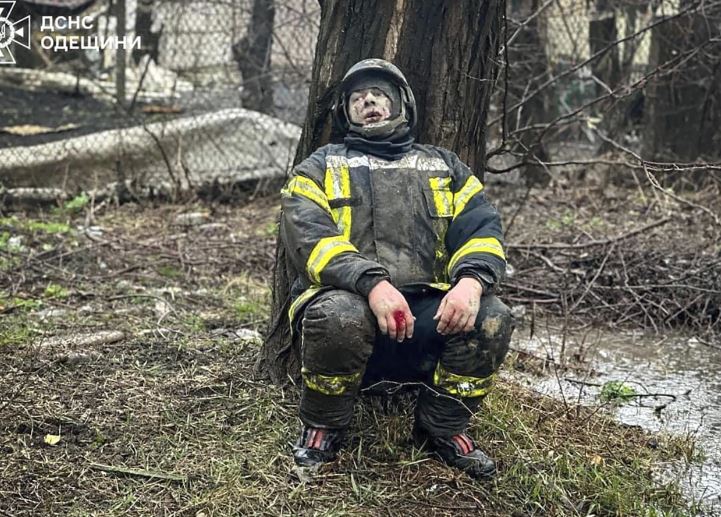An emergency serviceman sits shocked after a Russian attack in Odesa, Ukraine. Photo / AP