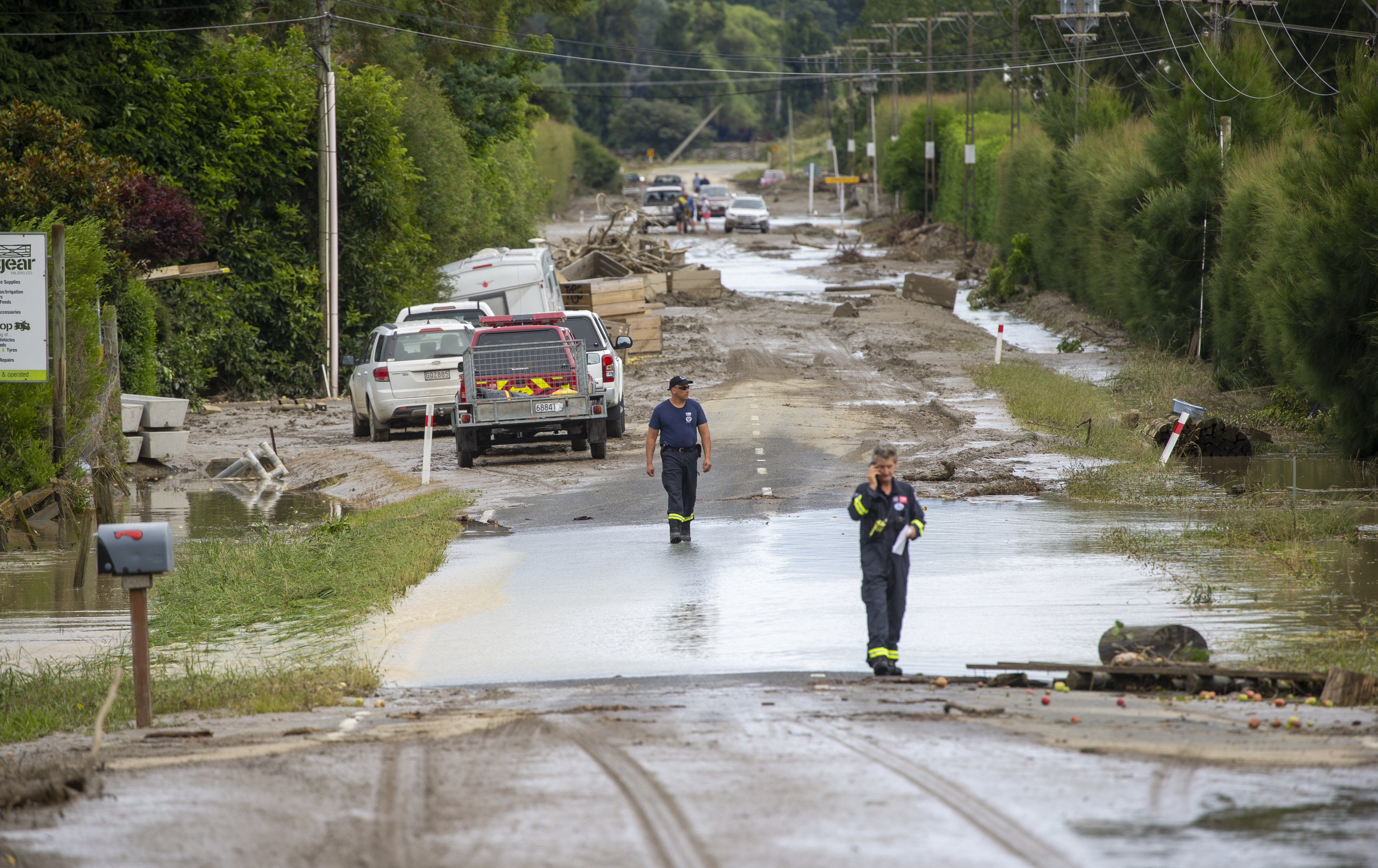 Rural communities still face plenty of challenges in the recover from Cyclone Gabrielle. Pictured are firefighters on Puketapu Rd, west of Napier, after the floods. Photo / Mark Mitchell