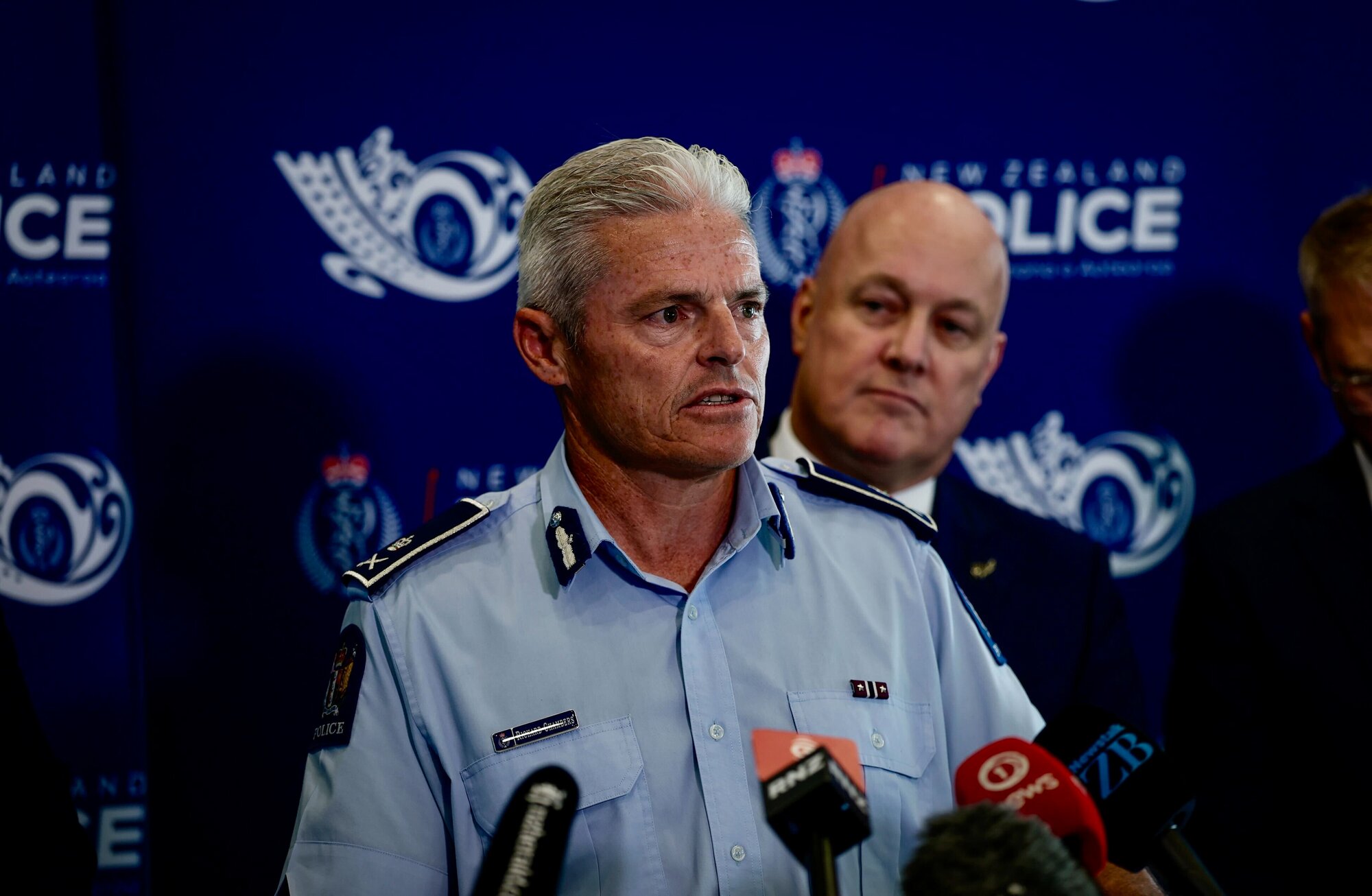 Police Commissioner Richard Chambers, with Prime Minister Christopher Luxon behind him. Photo / Dean Purcell