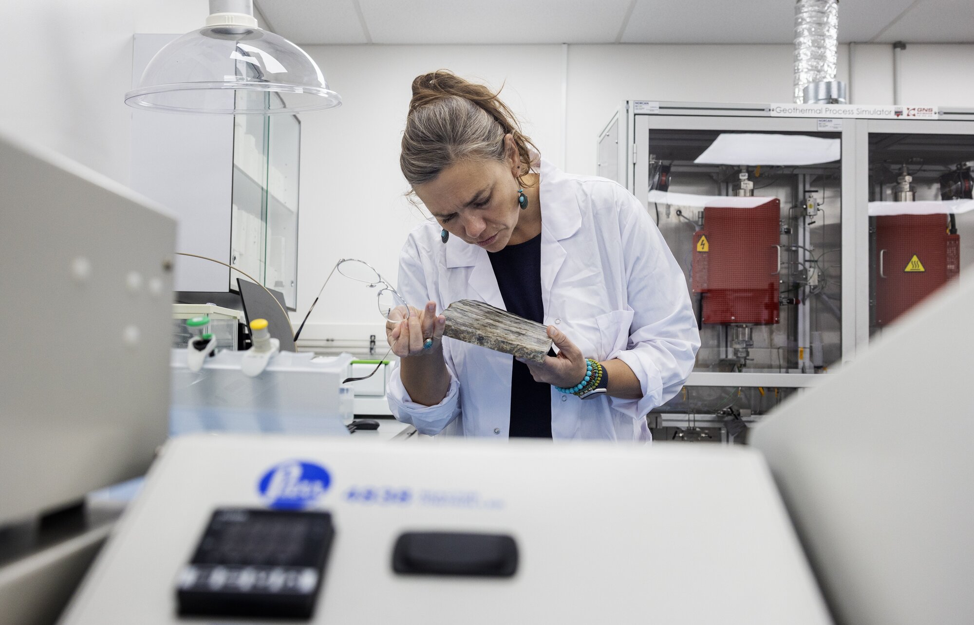 Dr Isabelle Chambefort, general manager – energy at Earth Sciences New Zealand, examines rock material. Photo / Mike Scott 