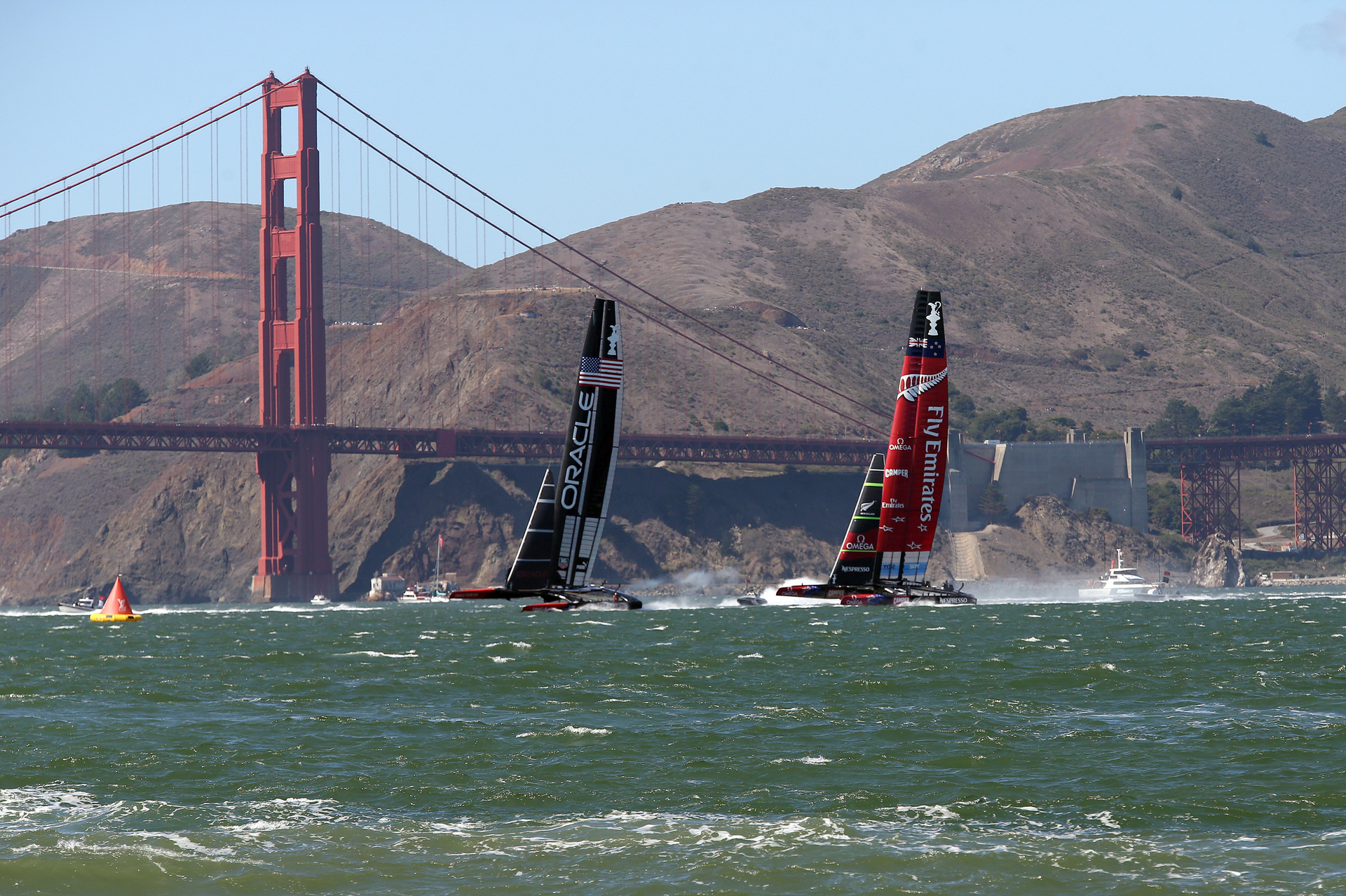 25 September 2013: Oracle's Team USA Racing 72 foot catamaran stakes an early lead on Emirates Team New Zealand during competition. Photo / Getty Images. 