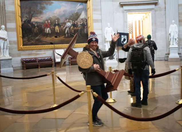 A rioter carries the lectern of US Speaker of the House Nancy Pelosi. Photo / Getty Images