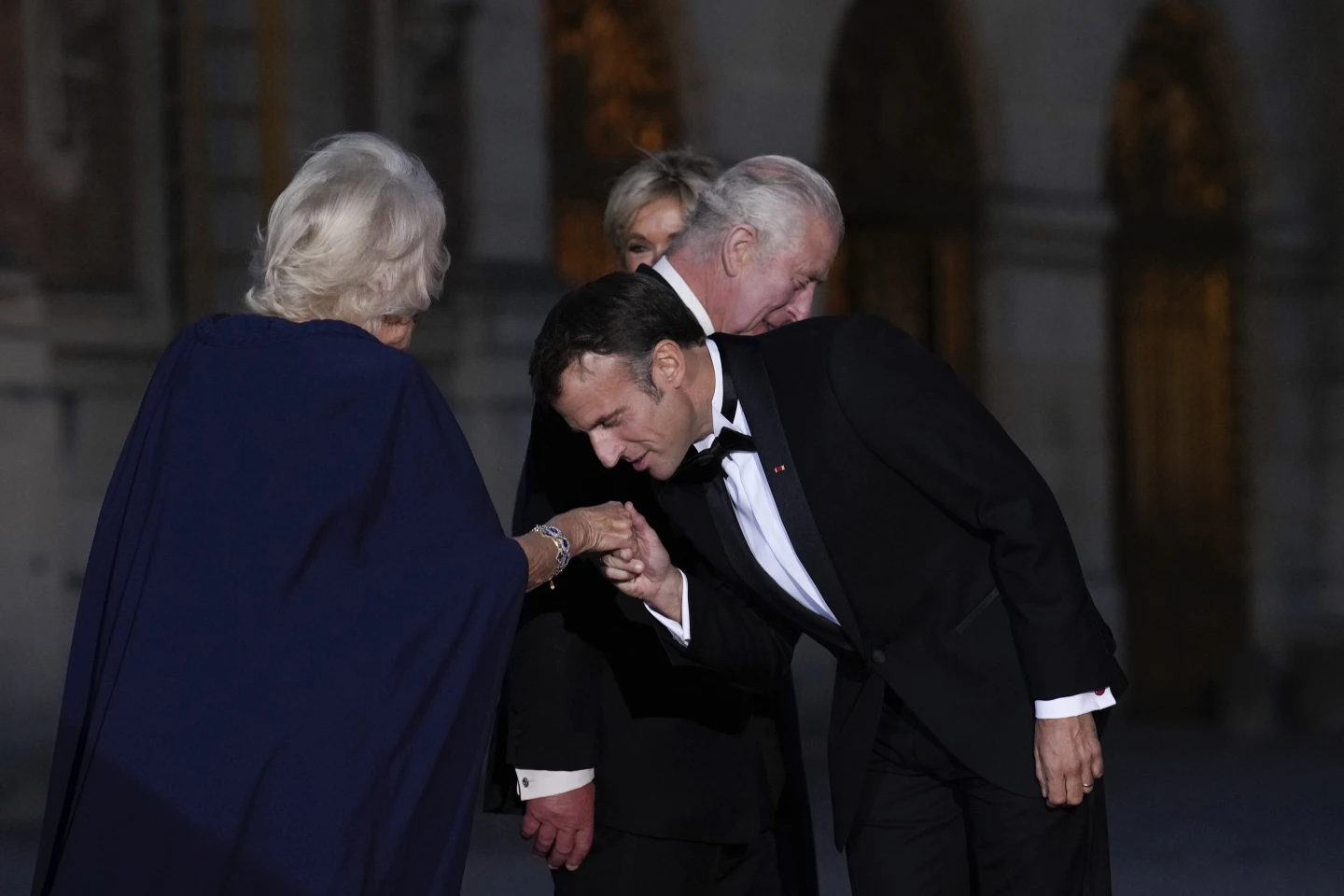 French President Emmanuel Macron kisses Britain's Queen Camilla hand. Photo / AP