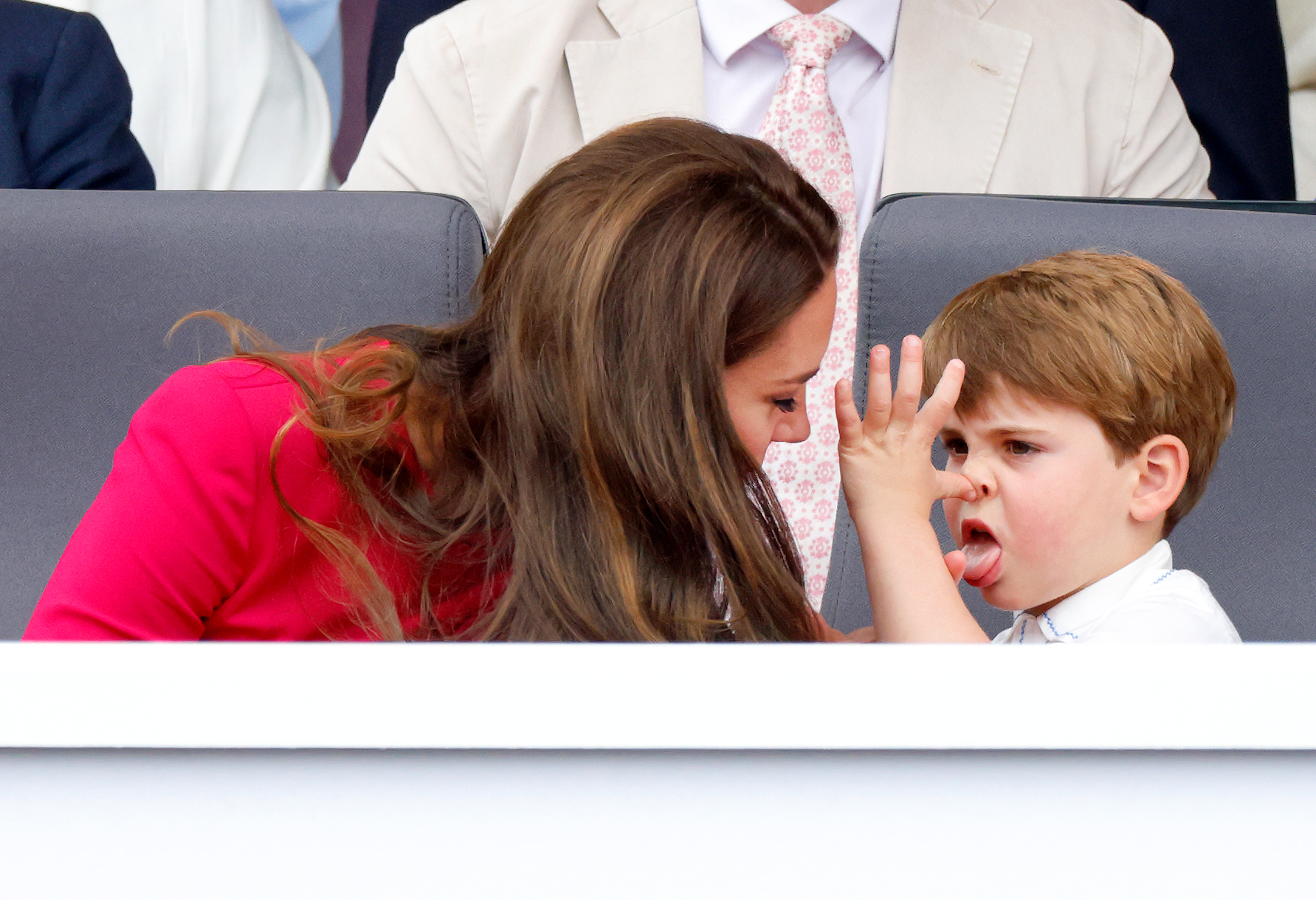 Prince Louis of Cambridge 'thumb's his nose' and sticks his tongue out at his mother Catherine, Duchess of Cambridge as they attend the Platinum Pageant on The Mall on June 5, 2022 in London, England. Photo / Getty Images