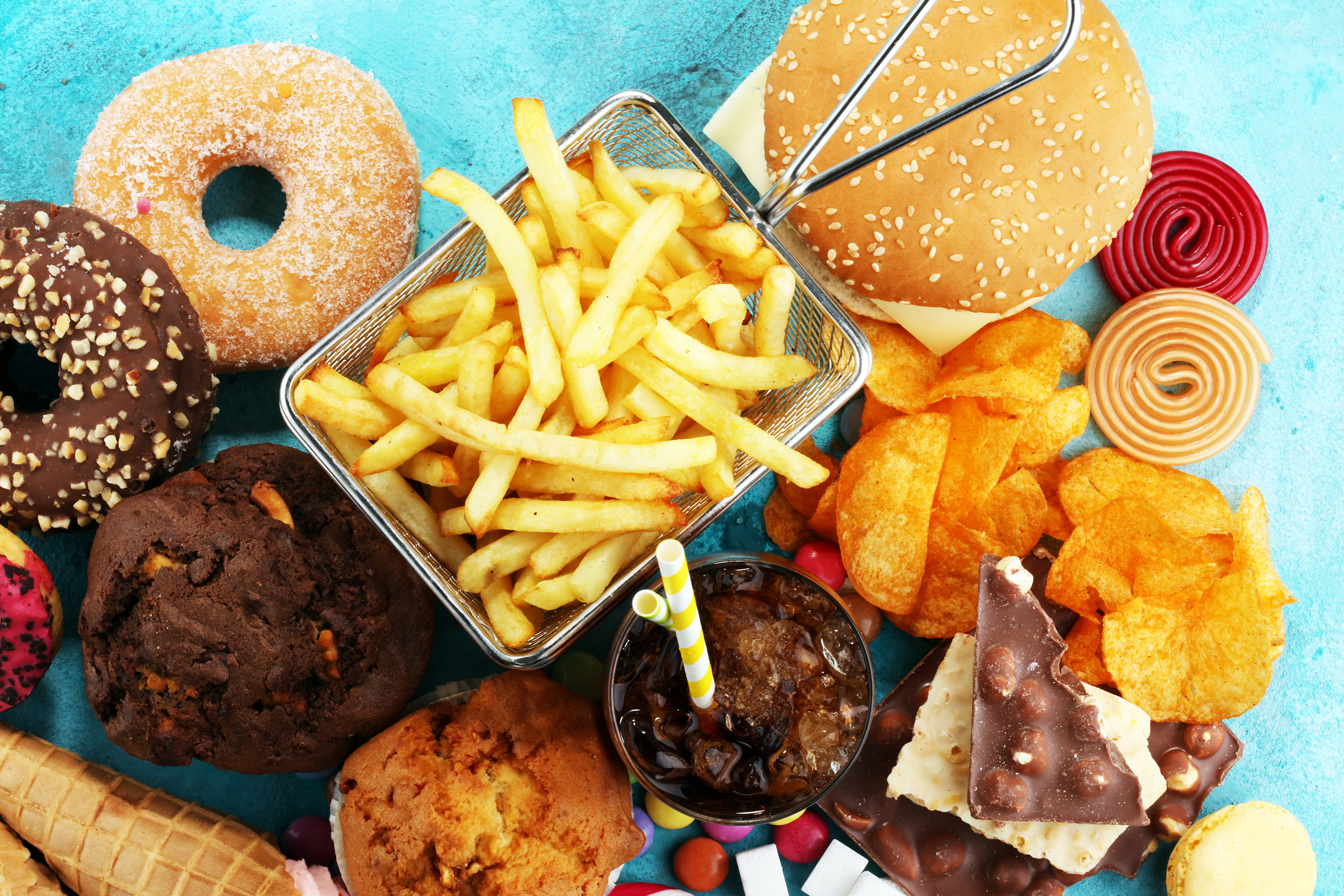 Highly processed foods include energy-dense, nutrient-poor foods such as takeaways, chips, biscuits, doughnuts, processed meats and soft drinks. Photo / 123RF
