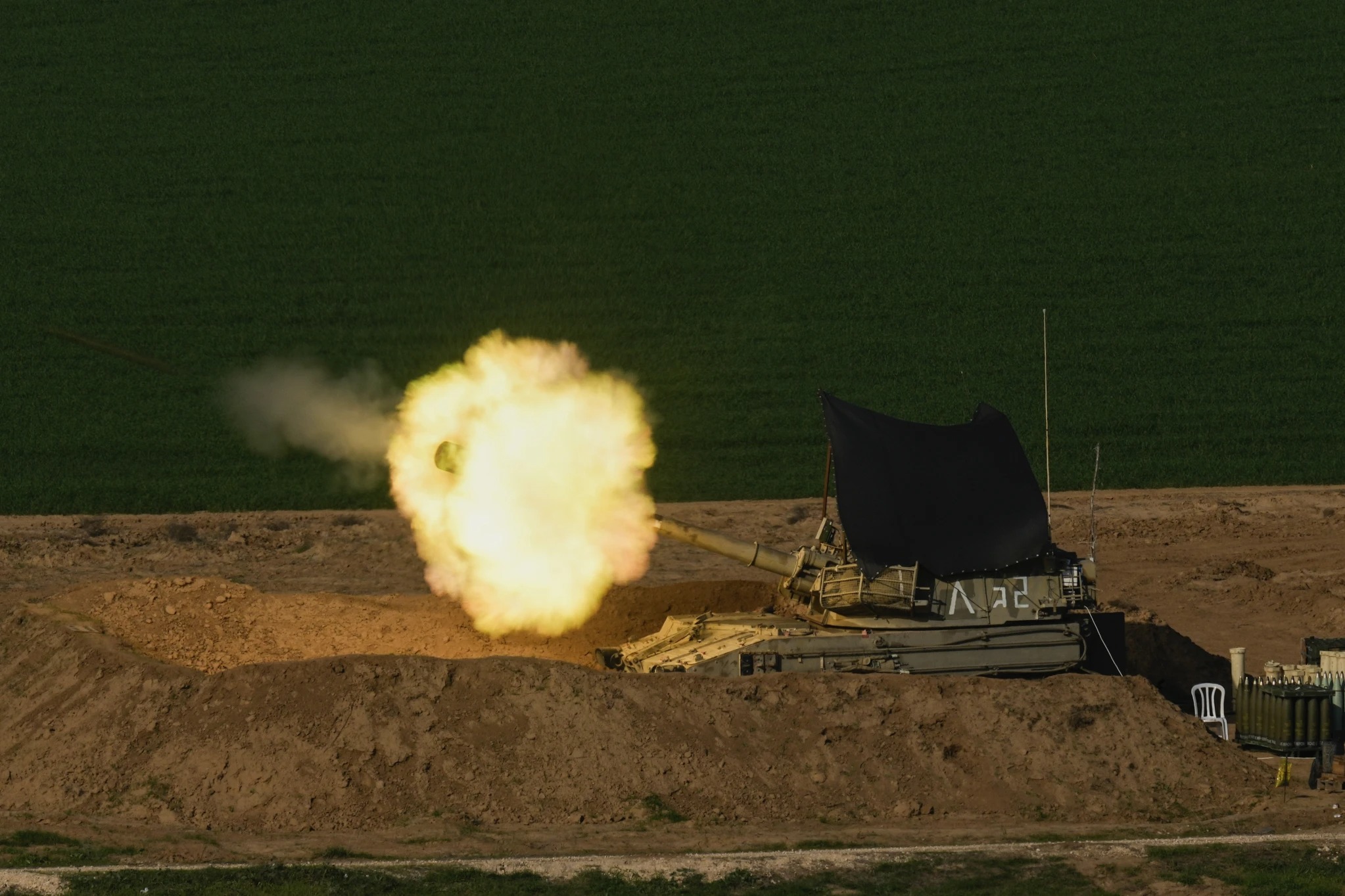 An Israeli mobile artillery unit fires a shell from southern Israel towards the Gaza Strip, in a position near the Israel-Gaza border. Photo / AP 