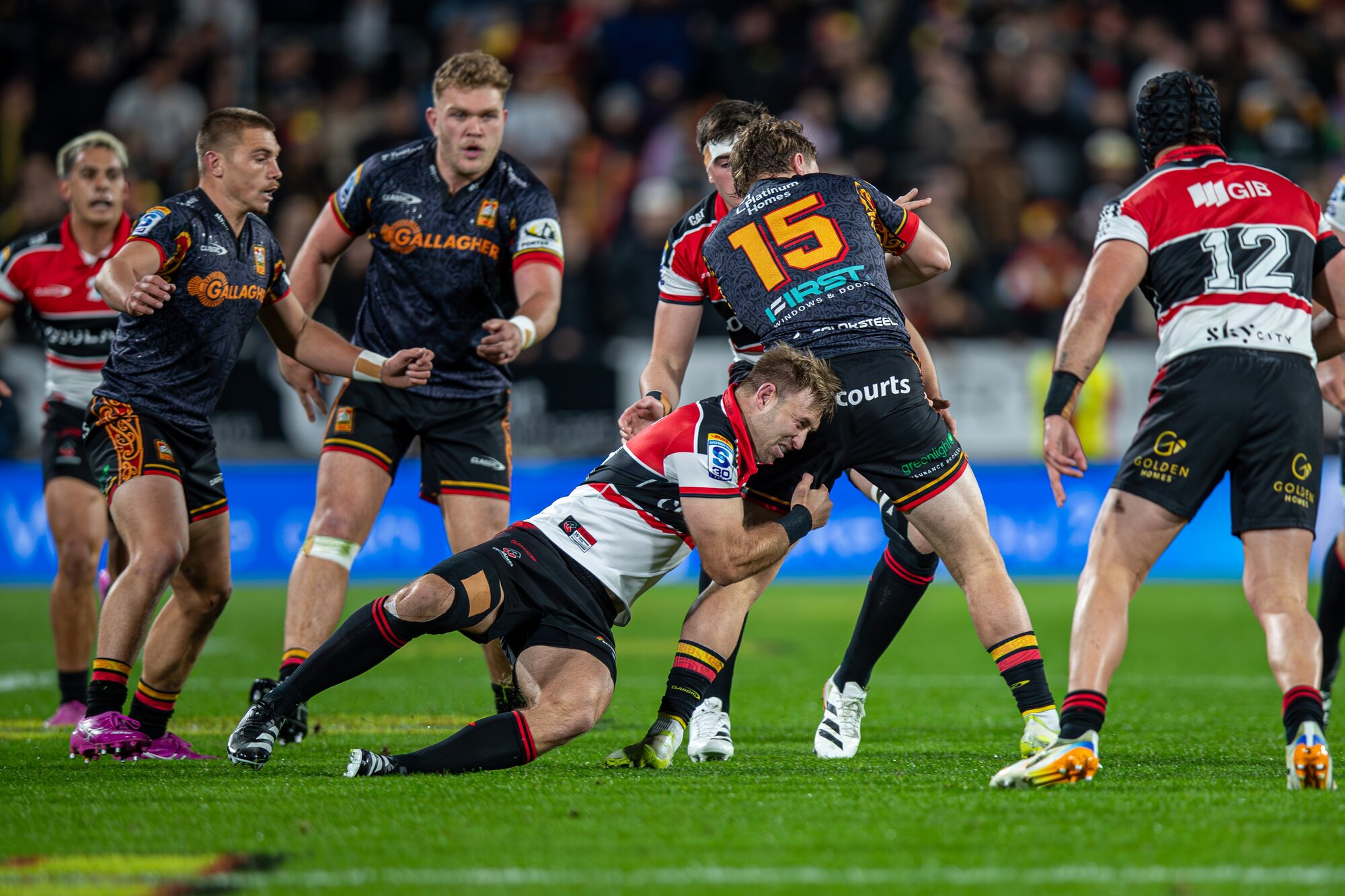 Crusaders midfielder Braydon Ennor tackles Chiefs fullback Isaac Hutchinson. Photo / Alyse Wright.