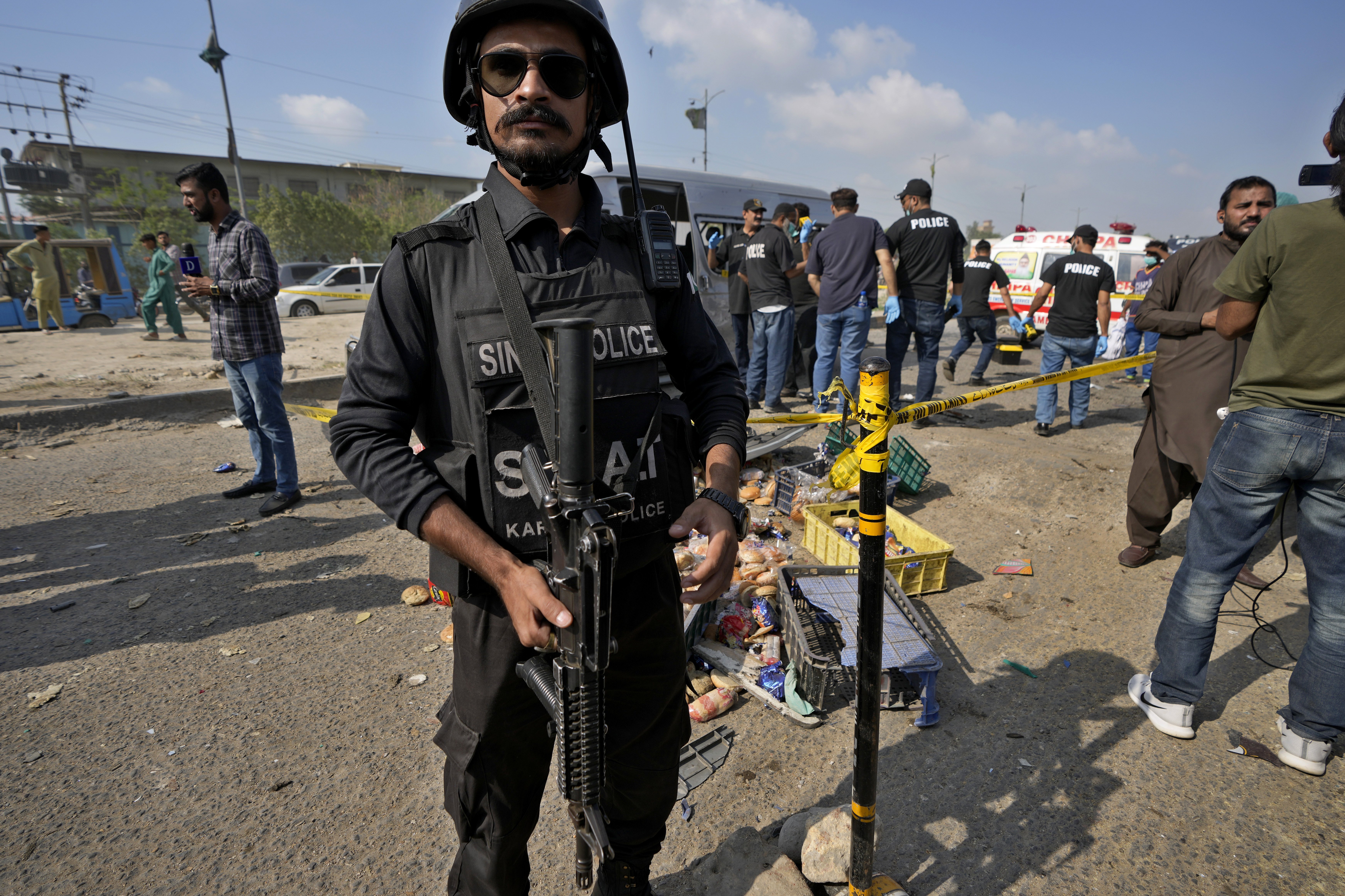 A police officer stands guard at the site of a suicide attack in Karachi, Pakistan. Photo / AP