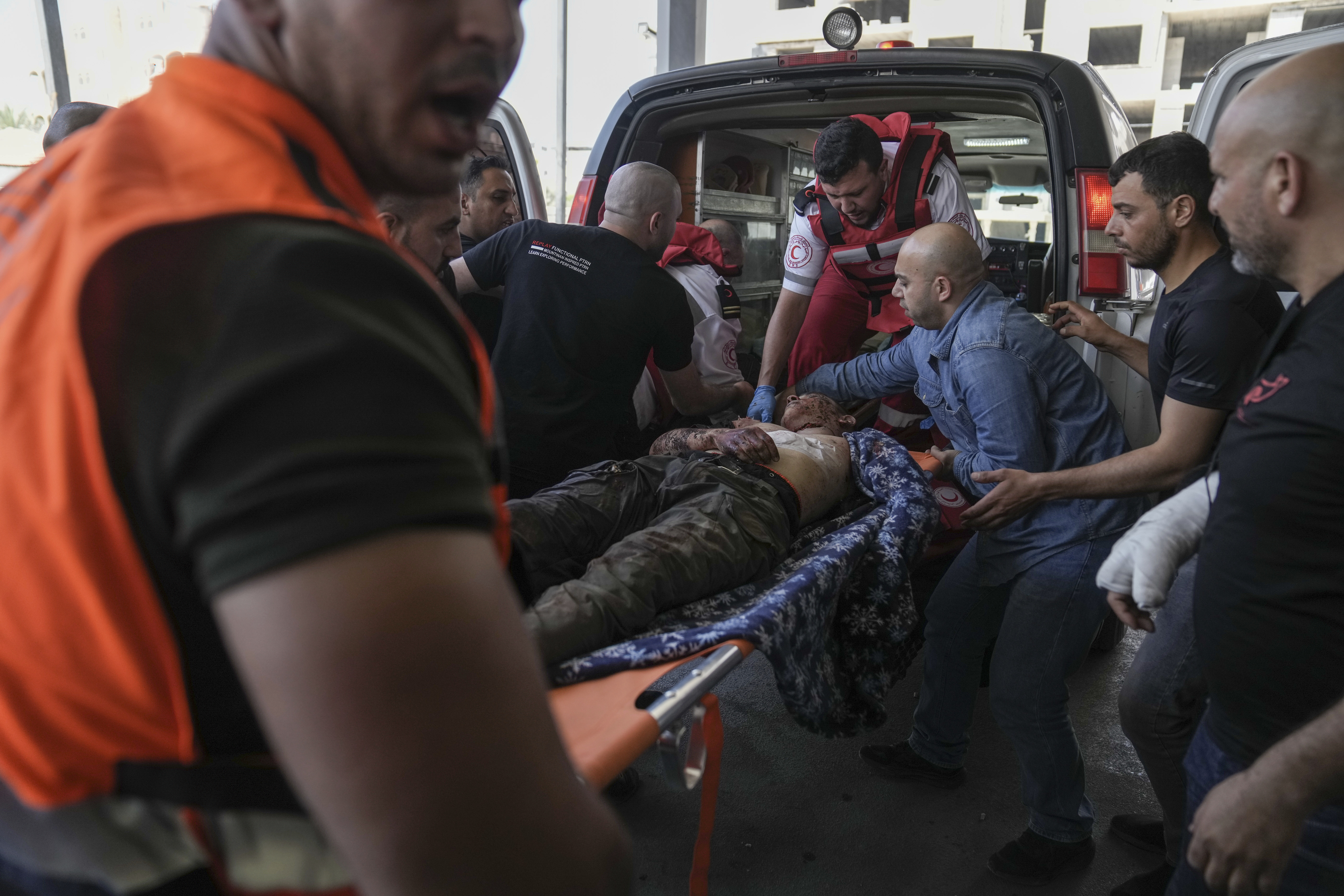 An injured Palestinian is carried into a hospital during an Israeli military raid in which Palestinian health officials said at least five Palestinians were killed. Photo / Nasser Nasser, AP
