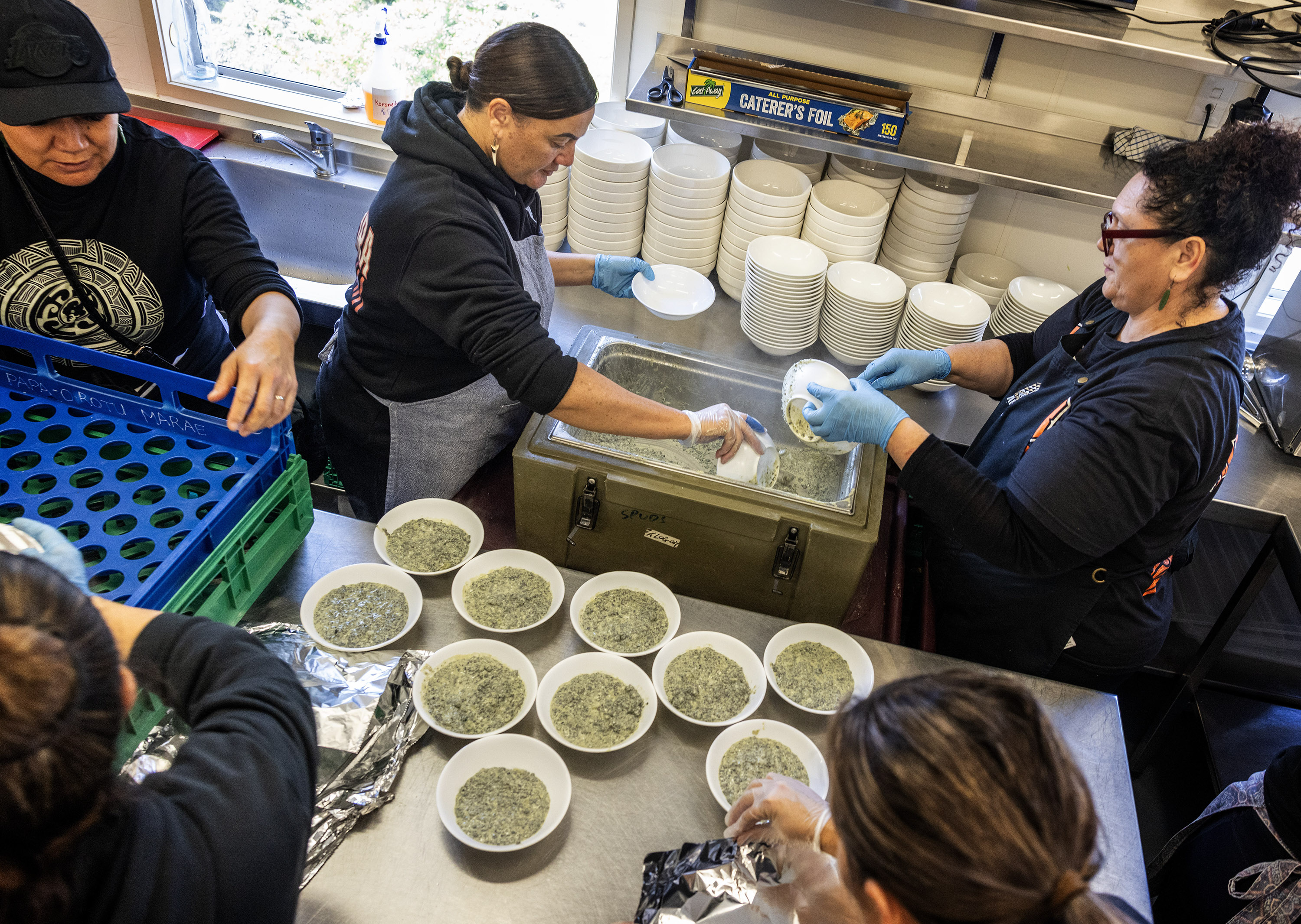 In the kitchen, meat goes into the steamers and boilers, salads are made, and desserts are sliced and plated. Photo / Mike Scott