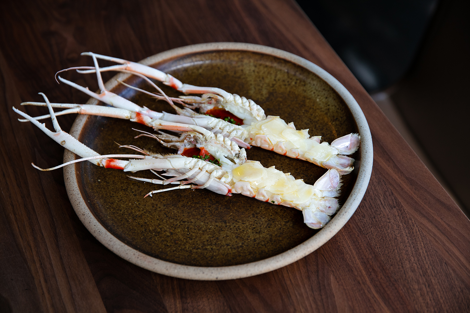 Whole scampi with tomato and garlic butter. Photo / Babiche Martens