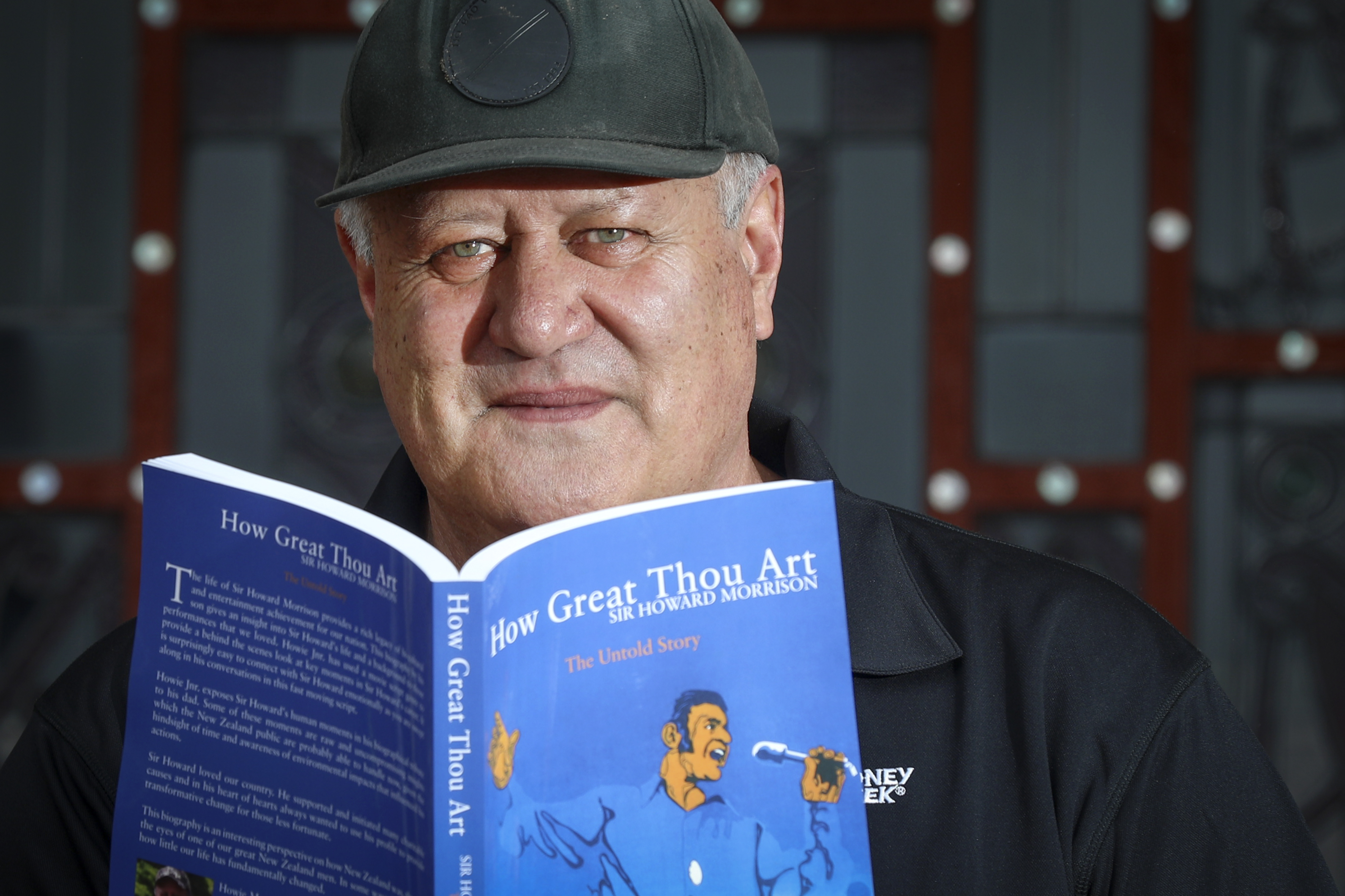Howie Morrison Junior with a copy of How Great Thou Art, his book about his dad, Sir Howard Morrison. Photo / Andrew Warner