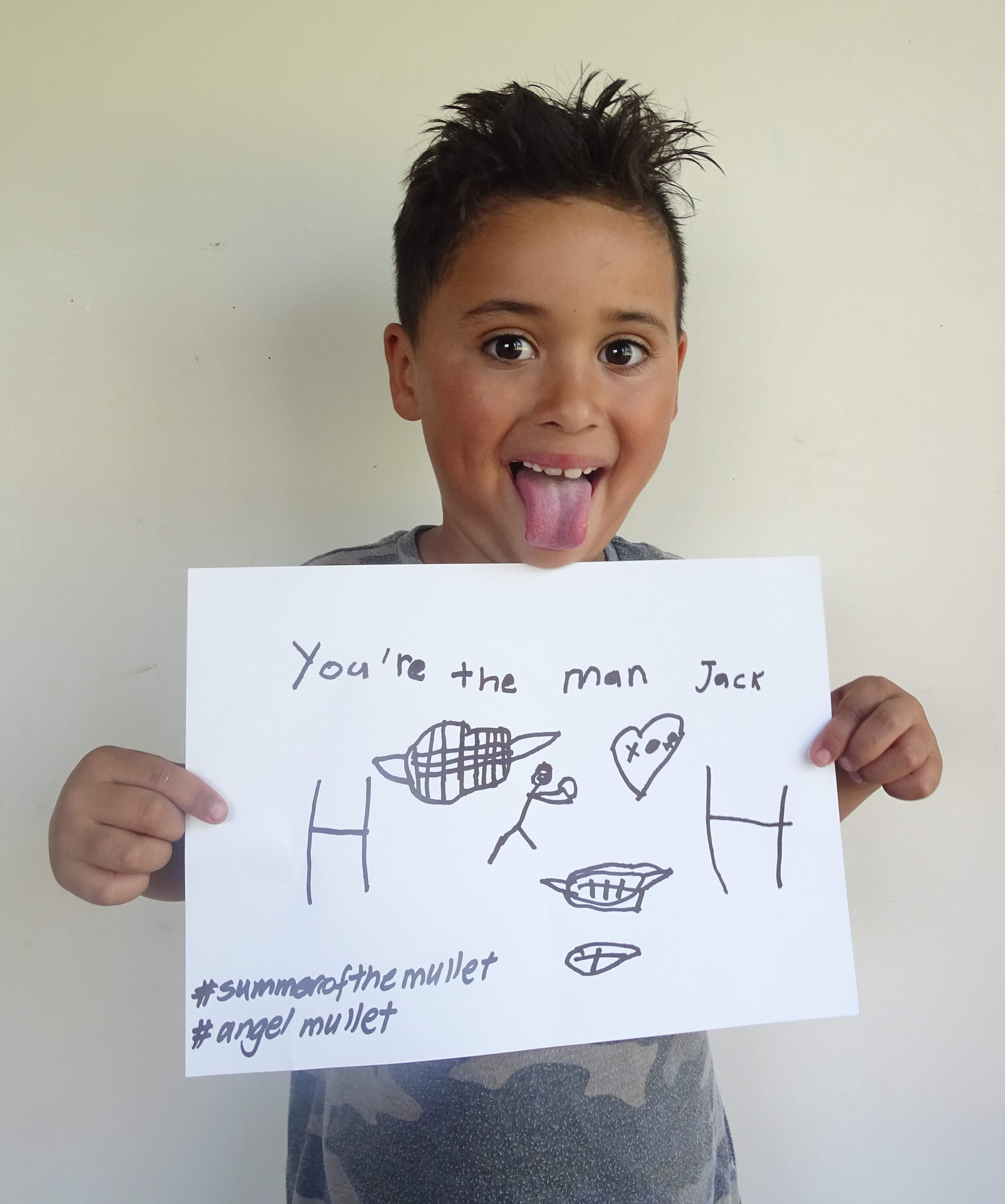Young Taonga Hau holds a sign saying