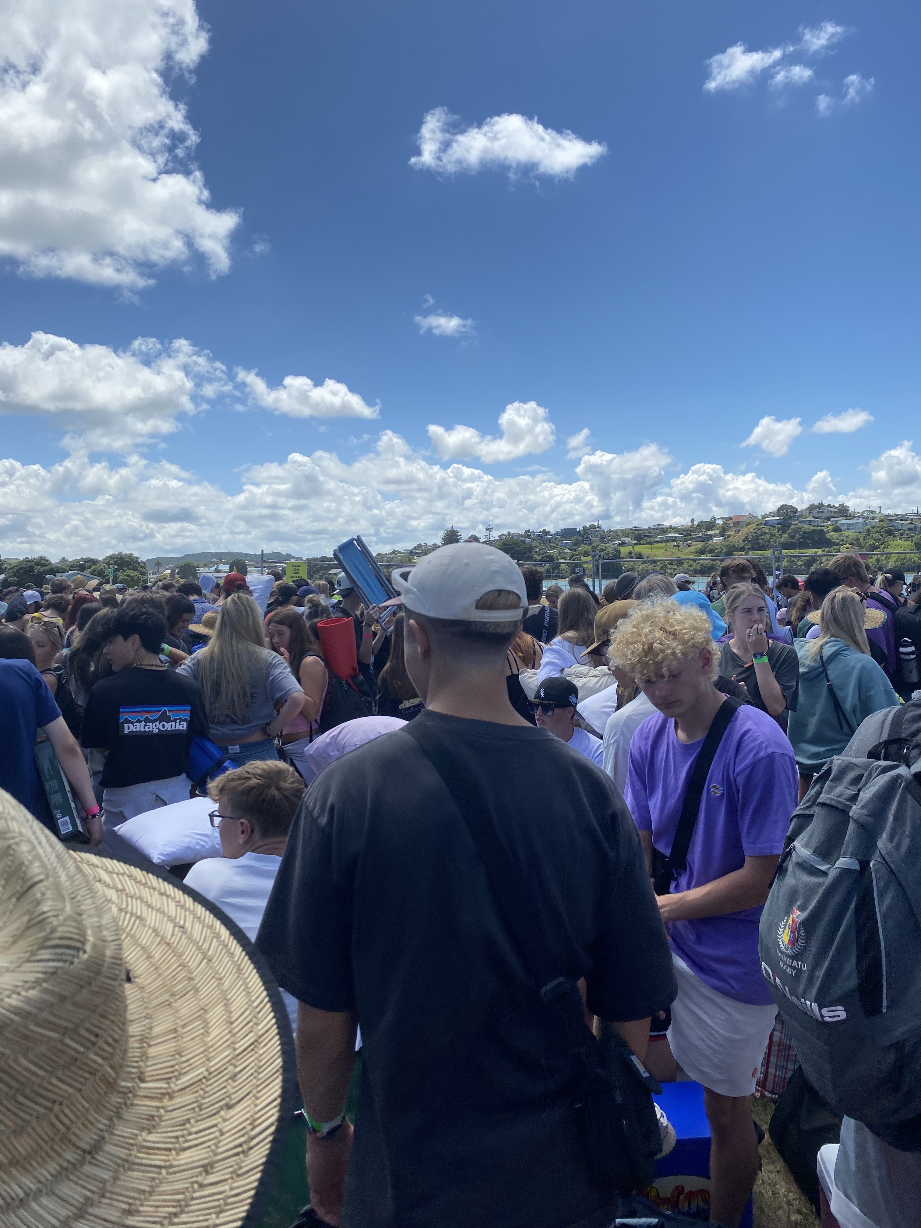 Teens wait to board buses at Raglan airfield for Soundsplash. Photo / Yasmin Robertson