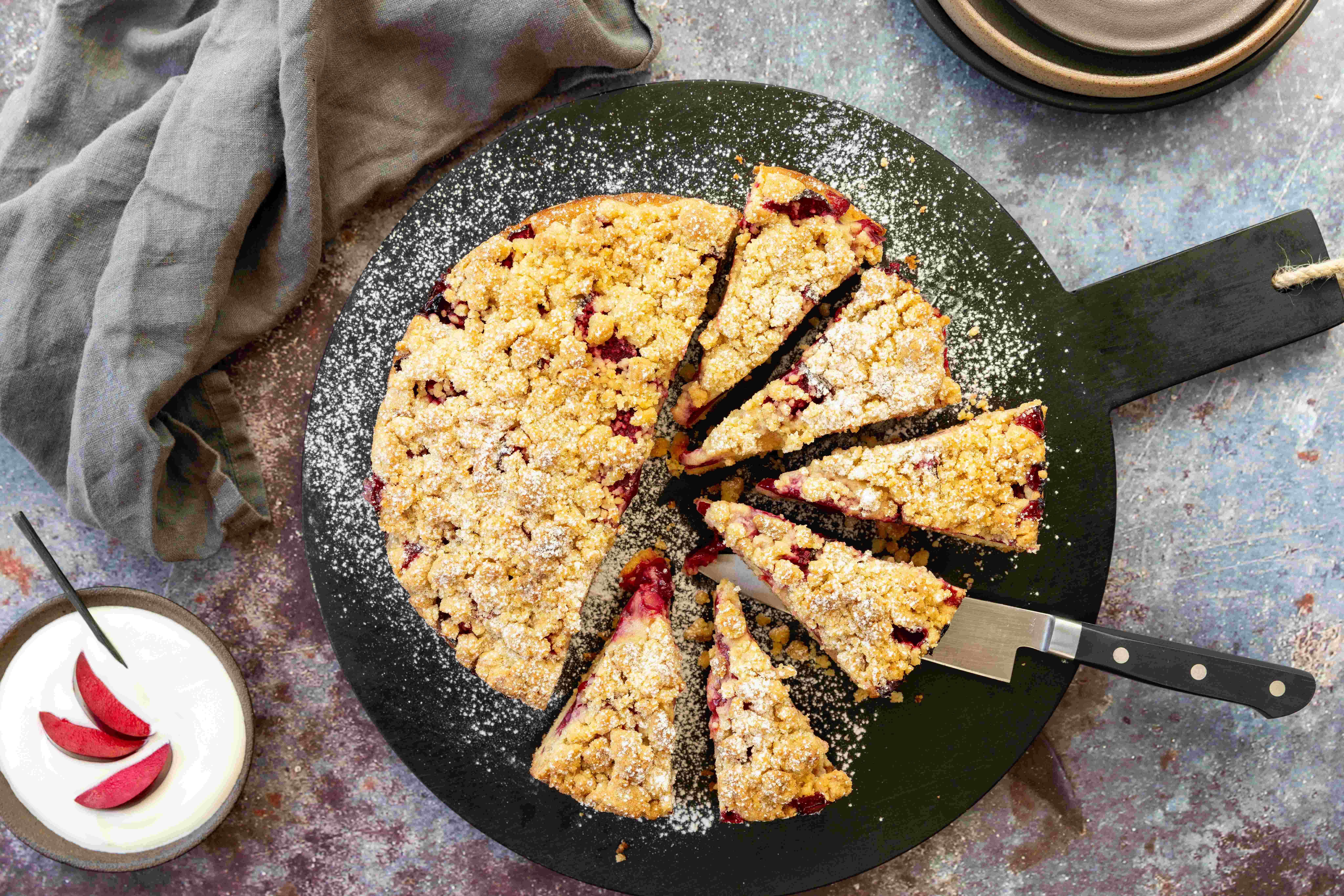 Finish this crumbly plum cake with a shower of icing sugar. Photo / Babiche Martens