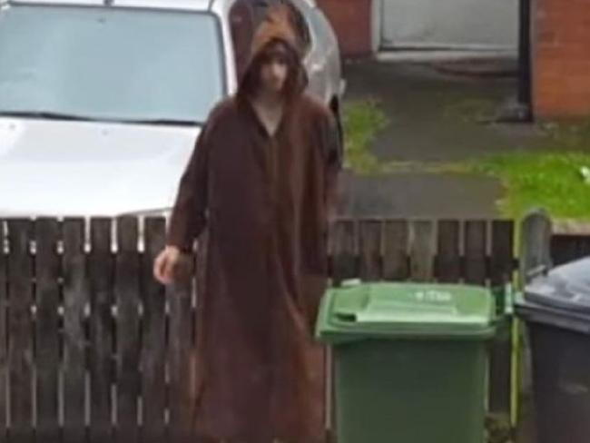 New pictures have emerged of Salman Abedi putting the bins out outside his Manchester home while wearing a brown robe.