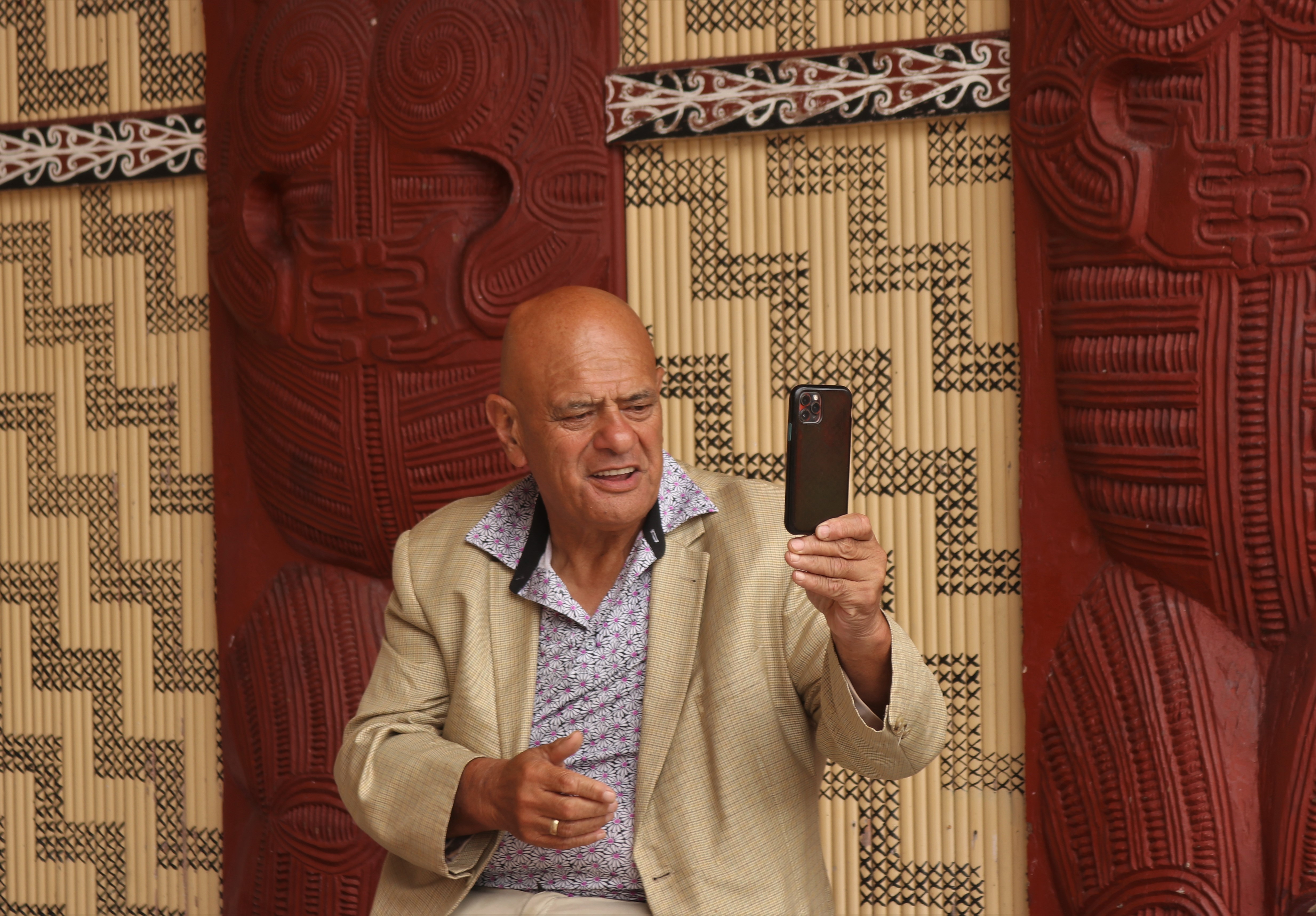 Ngāti Hine leader Waihoroi Shortland captures the festival action on his phone. Photo / Peter de Graaf