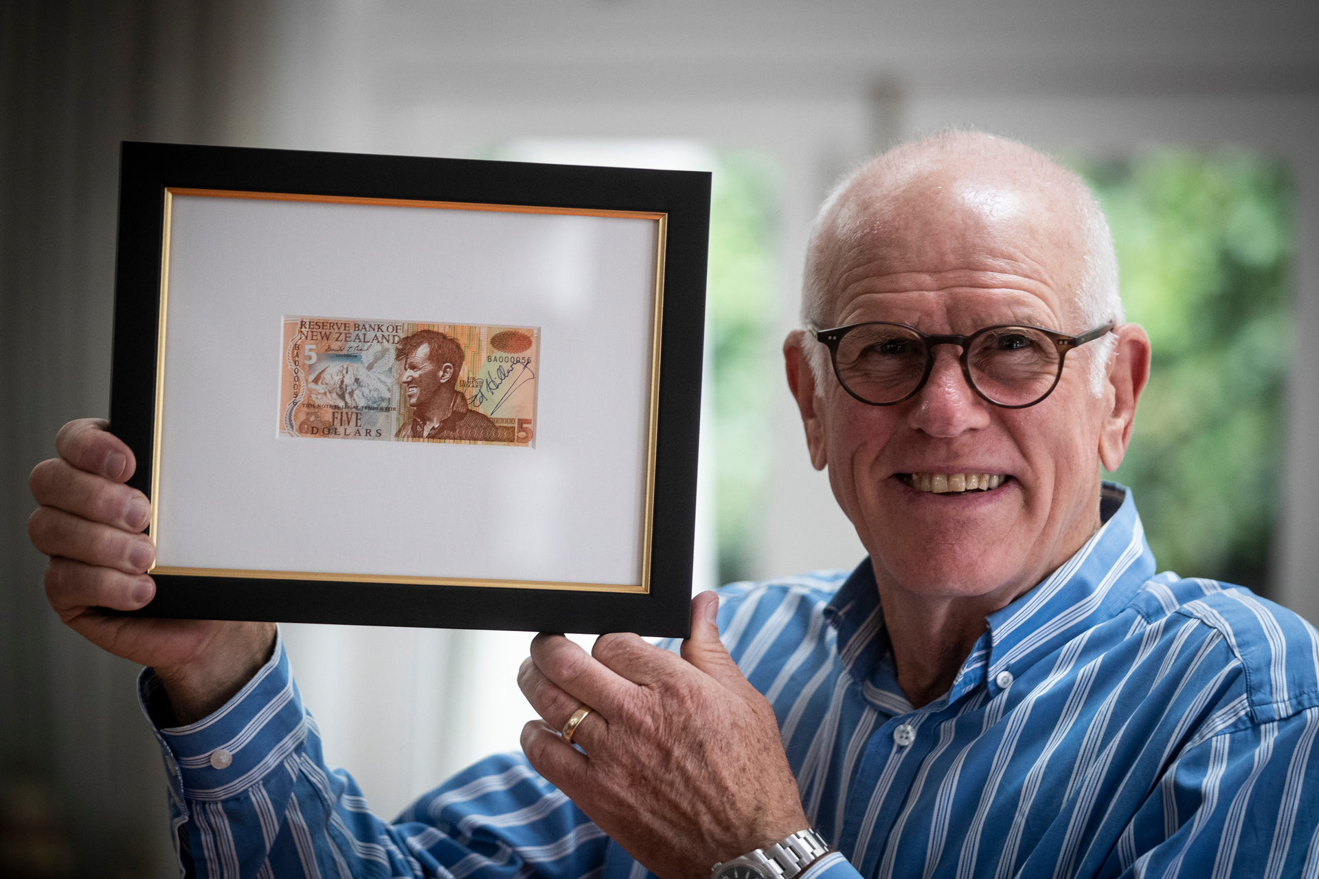 Peter Hillary with a signed $5 note signed by his father going up for auction. Photo / Jason Oxenham