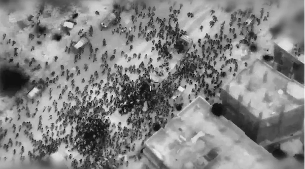 Palestinians swarm aid trucks near Gaza City before they were fired on by Israeli troops.