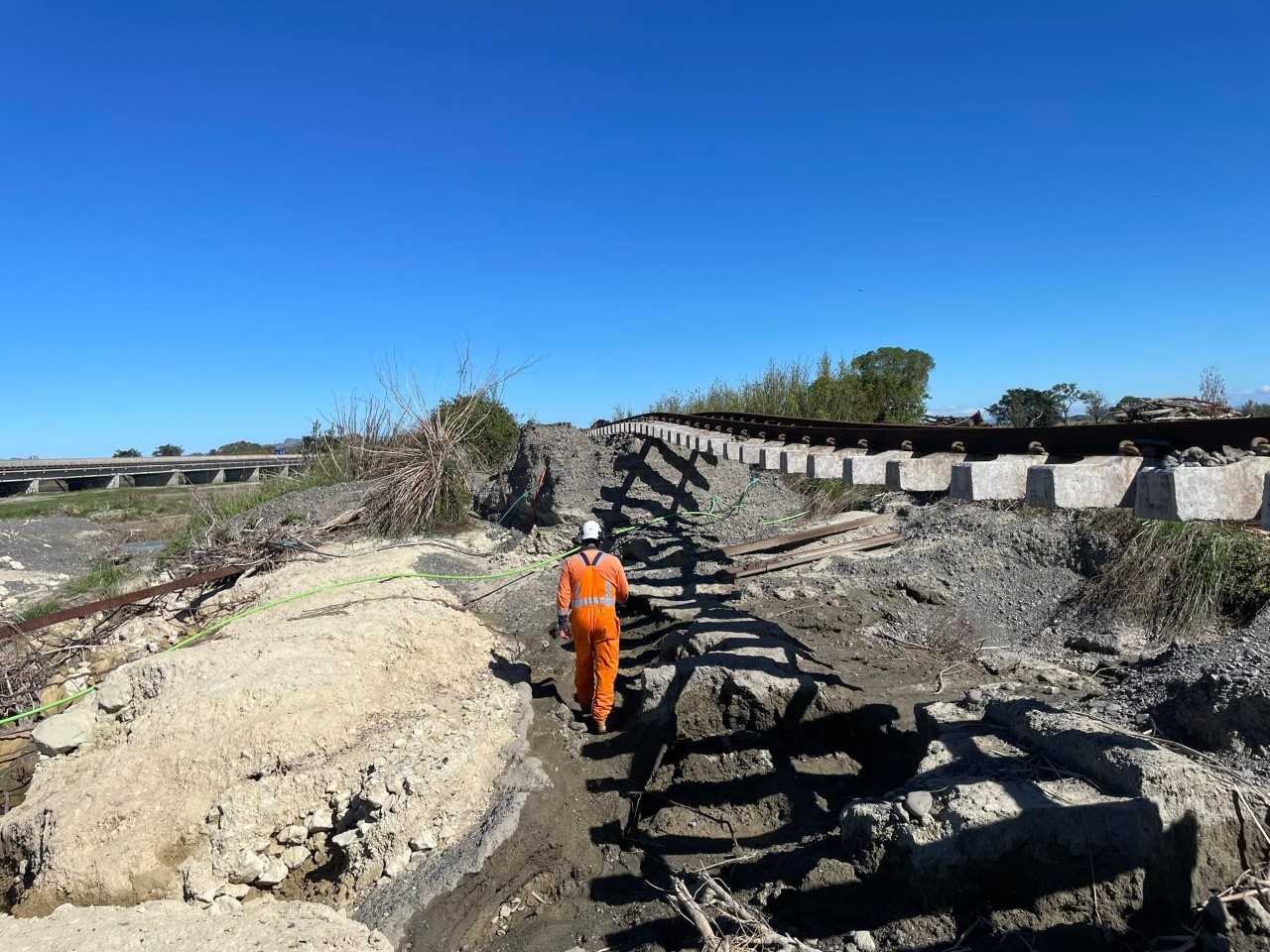 KiwiRail teams assess the flood-damaged rail line in Awatoto. Photo / Supplied
