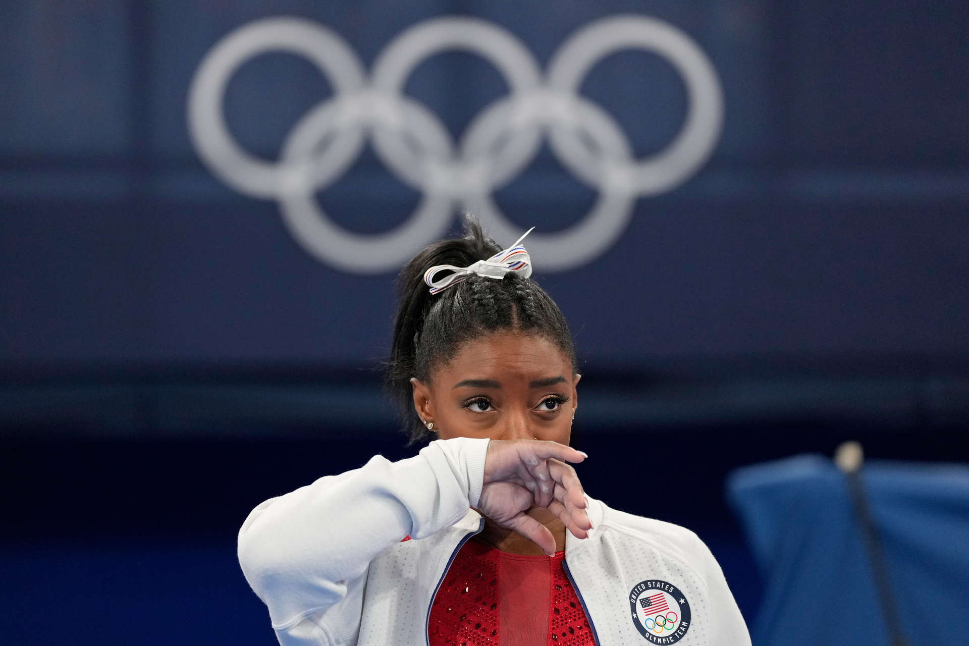 Simone Biles, of the United States, watches gymnasts perform after she exited the team final. Photo / AP